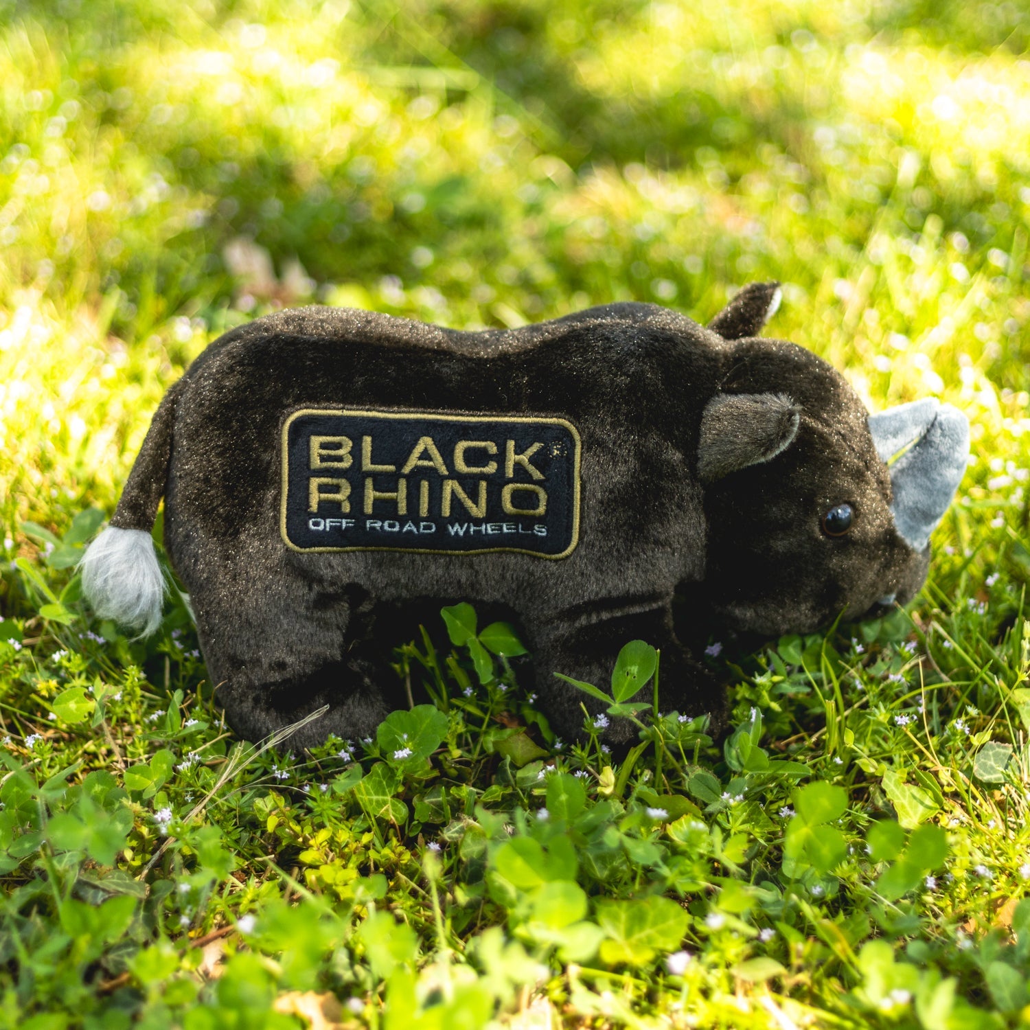 Black Rhino plush toy with soft fur, oversized ears, and a smiling face, perfect for cuddling and playtime.