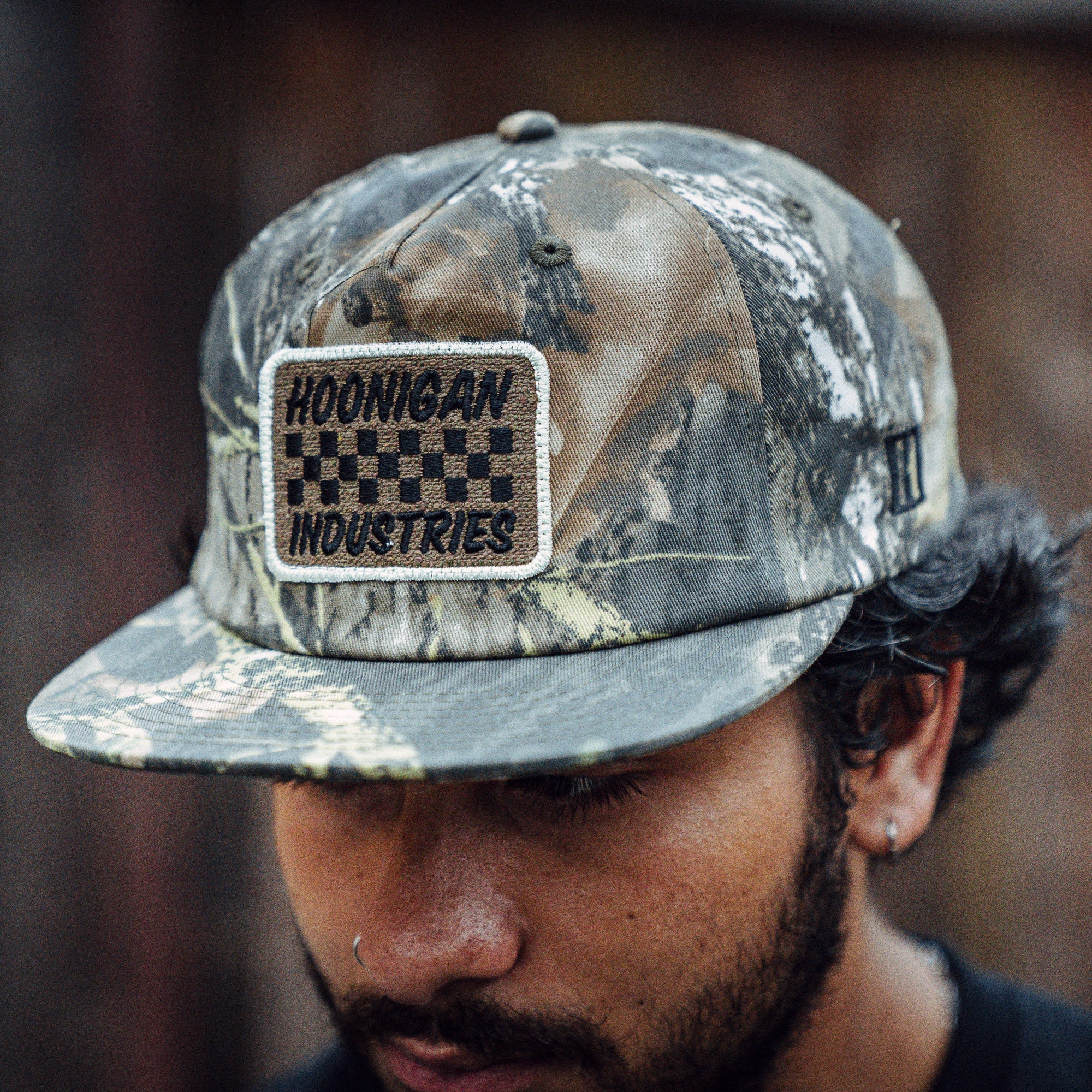 Hoonigan SPRINT unstructured snapback hat featuring a camouflage design and embroidered logo patch.