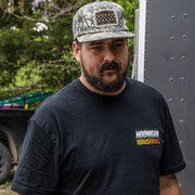 Man wearing a black Hoonigan SLIDEWAYS short sleeve t-shirt, showcasing automotive lifestyle and car culture.