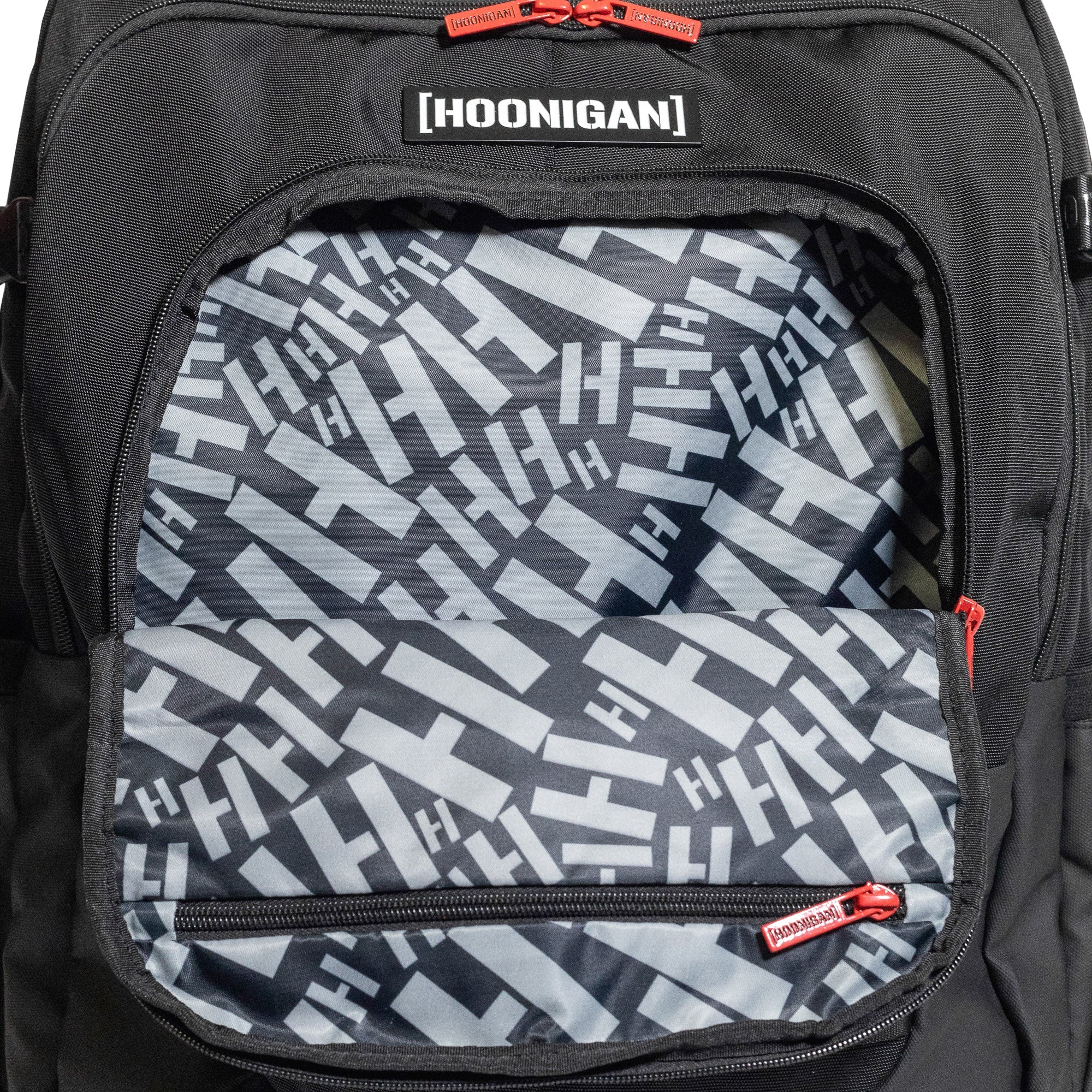 Hoonigan RATCHET STRAP Backpack featuring a durable design with adjustable straps and bold branding, ideal for outdoor and urban use.