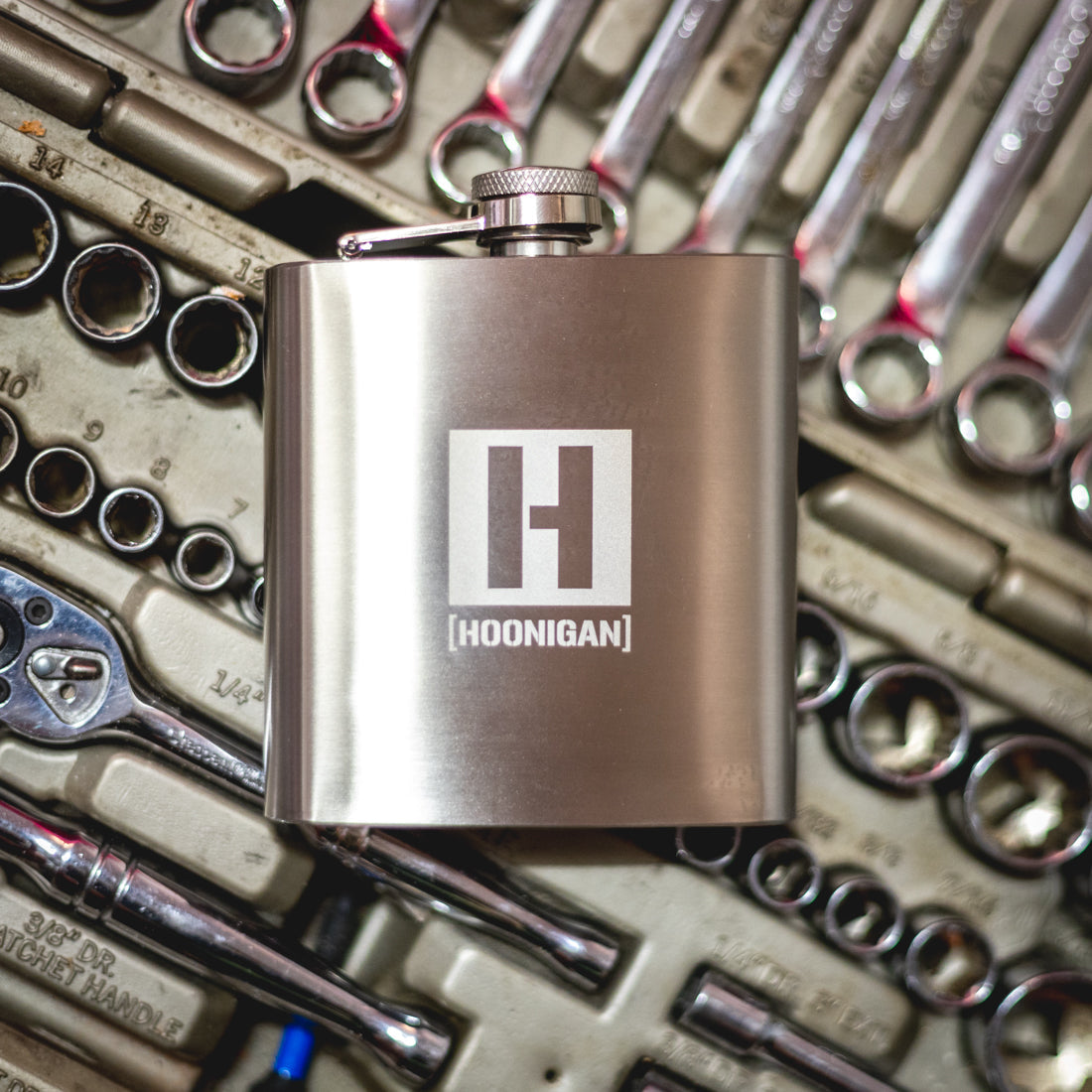 Hoonigan H BOX 6oz stainless steel flask with a black matte finish and Hoonigan logo design.