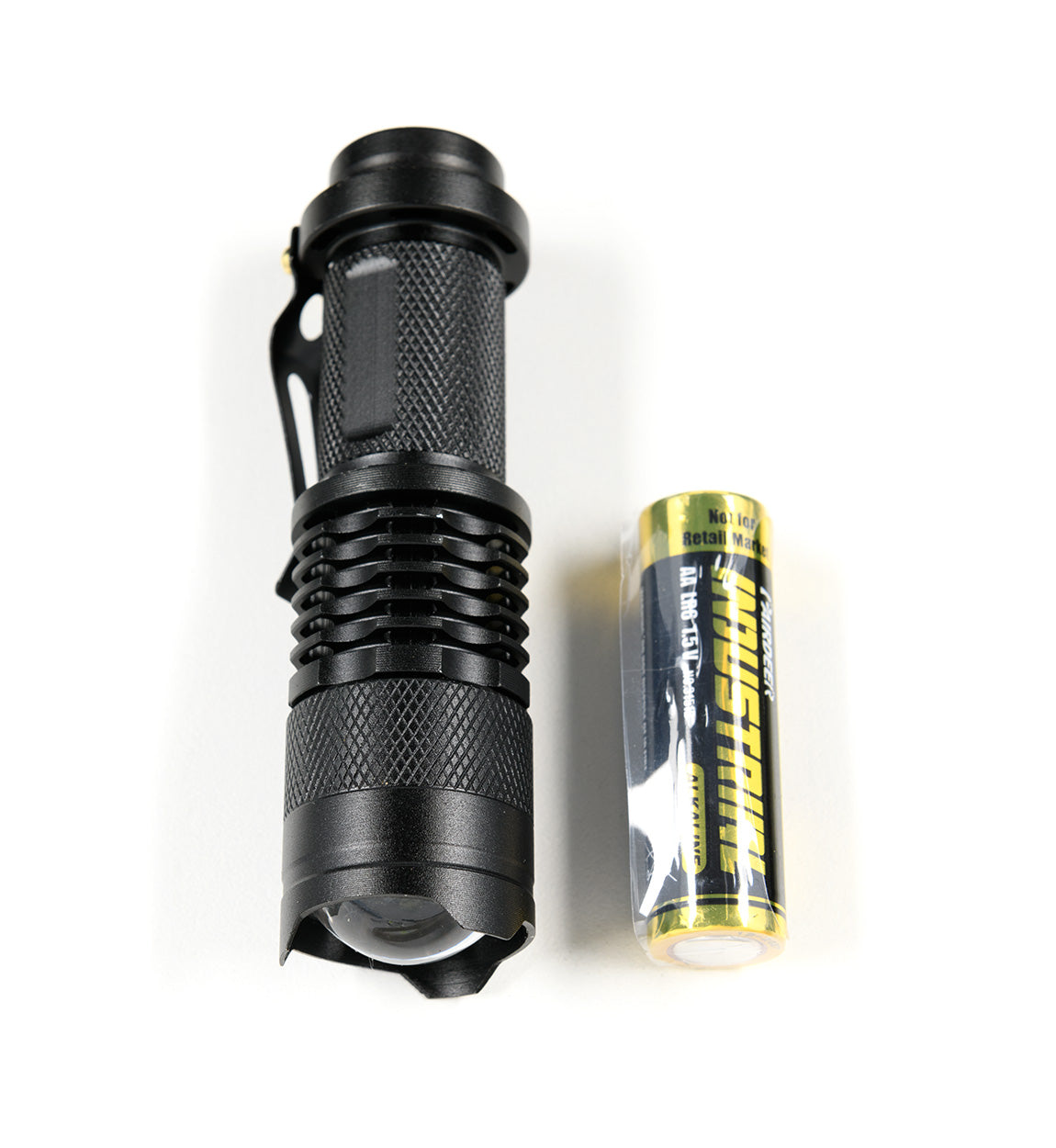 Black safety flashlight with knurled grip and a yellow battery, part of the Hoonigan OH SH*T Safety Kit.