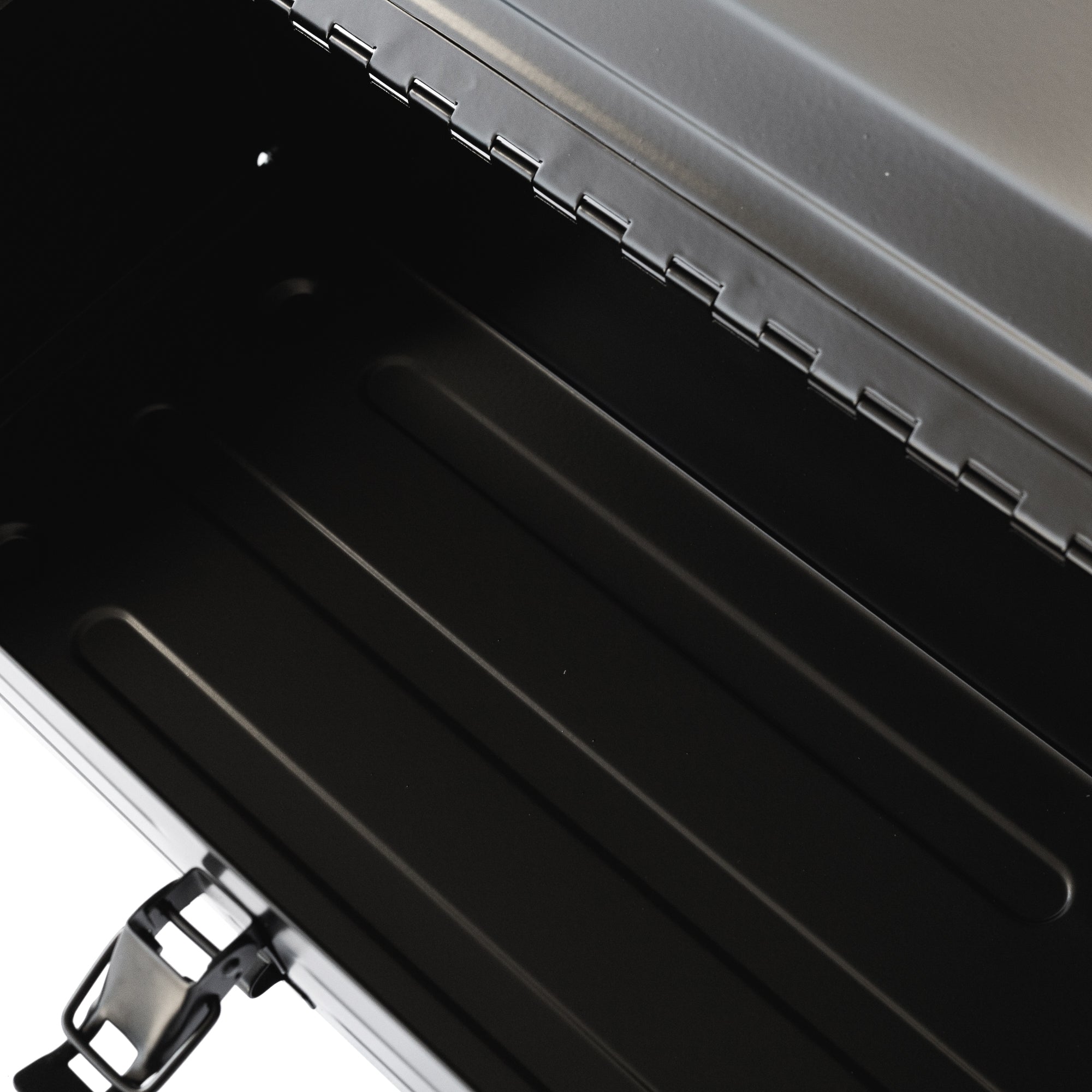 Hoonigan metal tool box with a spacious, black interior and a sturdy lid, designed for durability and organization.