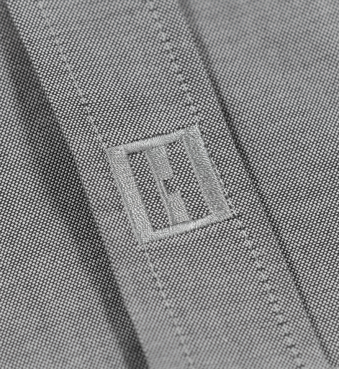 Hoonigan DONUT GARAGE gray woven short sleeve button-up shirt displayed on a hanger.