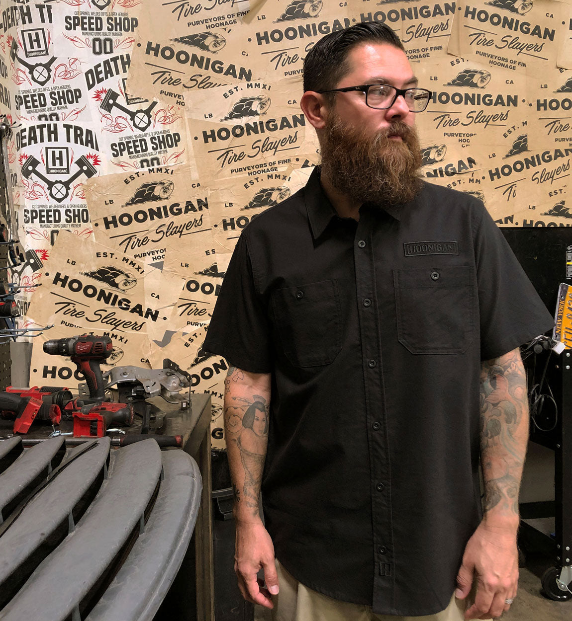 Hoonigan DONUT GARAGE black woven short sleeve button-up shirt with logo detailing.