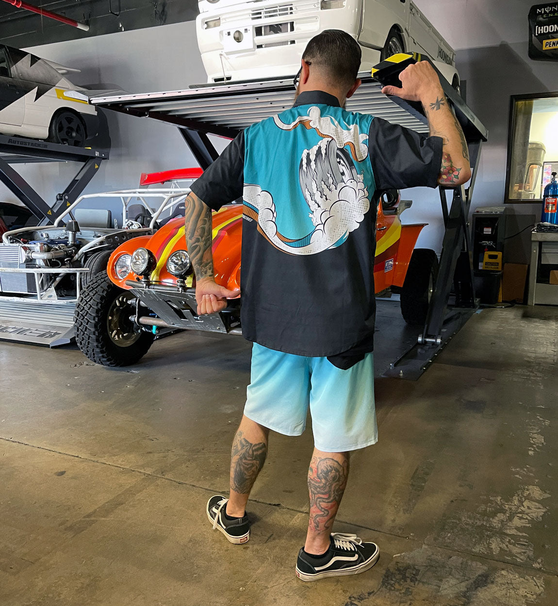 Hoonigan WAVE OF MUTILATION black woven short sleeve button-up shirt featuring a colorful graphic design on the front.