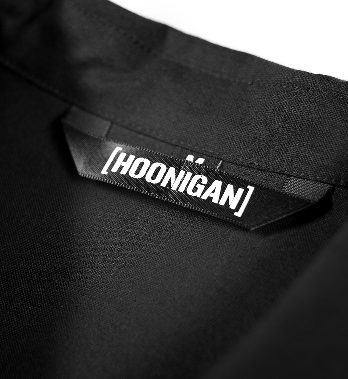 Black Hoonigan DONUT GARAGE woven short sleeve button-up shirt with a front pocket and subtle logo detailing.