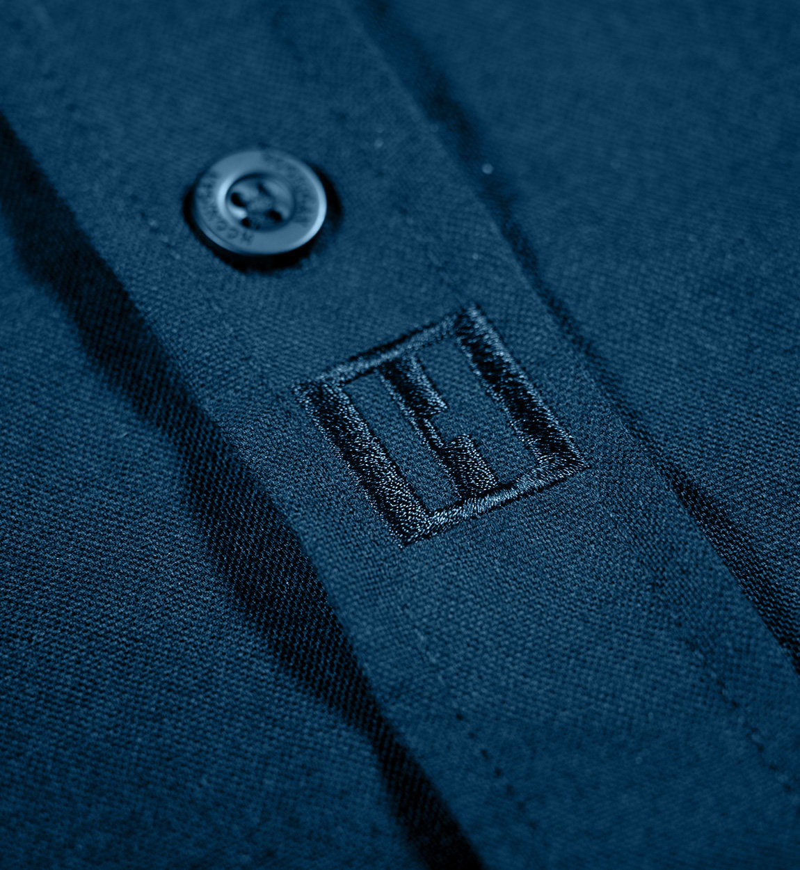 Hoonigan DONUT GARAGE woven long sleeve button-up shirt in navy, featuring a classic collar and button-down front with subtle logo detailing.