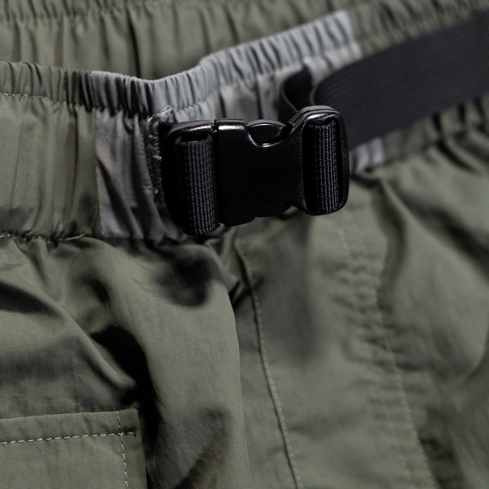 Close-up of Hoonigan H.A.V.O.C. rain-activated cargo shorts with adjustable waistband and durable buckle detail.