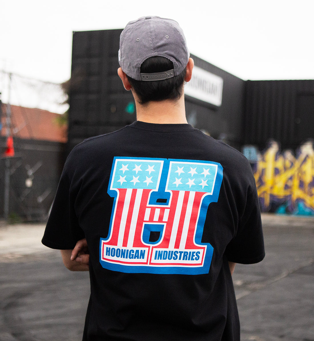 Hoonigan HARDTAIL Black Short Sleeve Tee displayed on a model, featuring bold logo graphics.