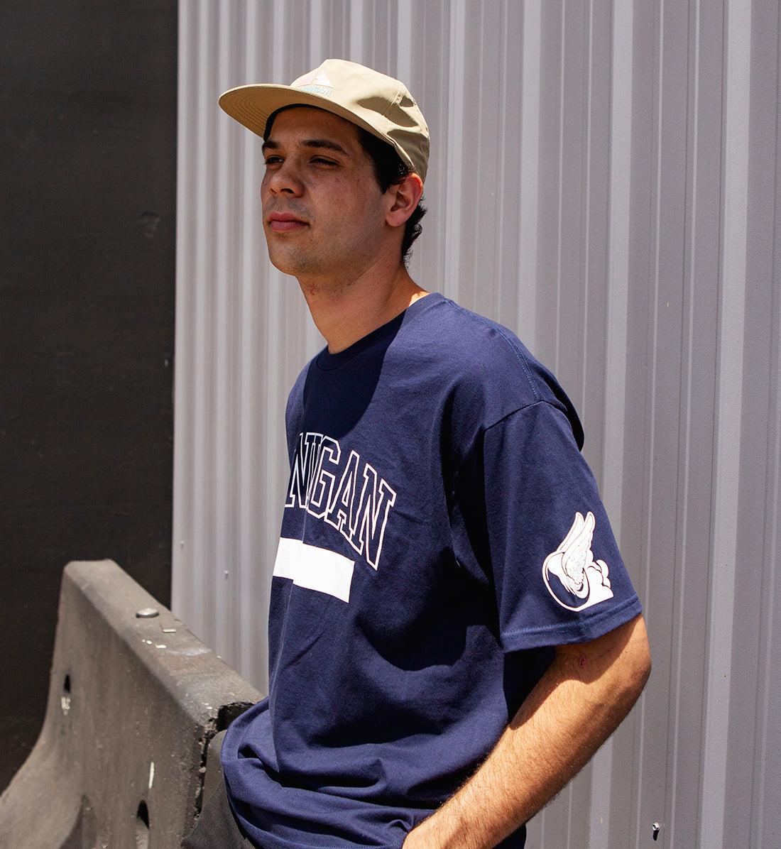 Hoonigan UNATHLETIC short sleeve navy tee displayed on a model, featuring the bold "UNATHLETIC" graphic on the front.