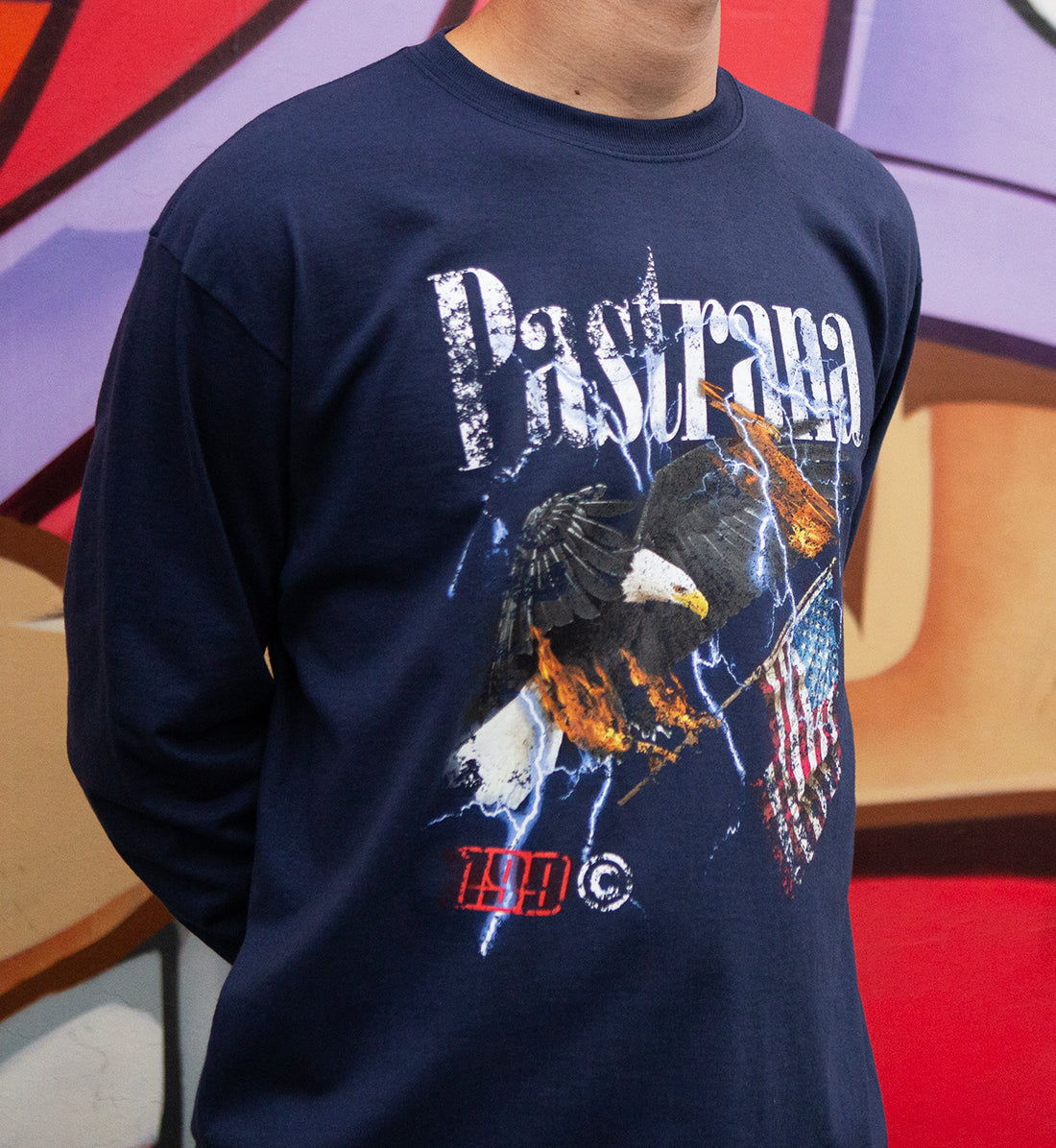 Travis Pastrana FLY HIGH long sleeve tee in navy, featuring a stylish graphic design on the front, worn by a model outdoors.