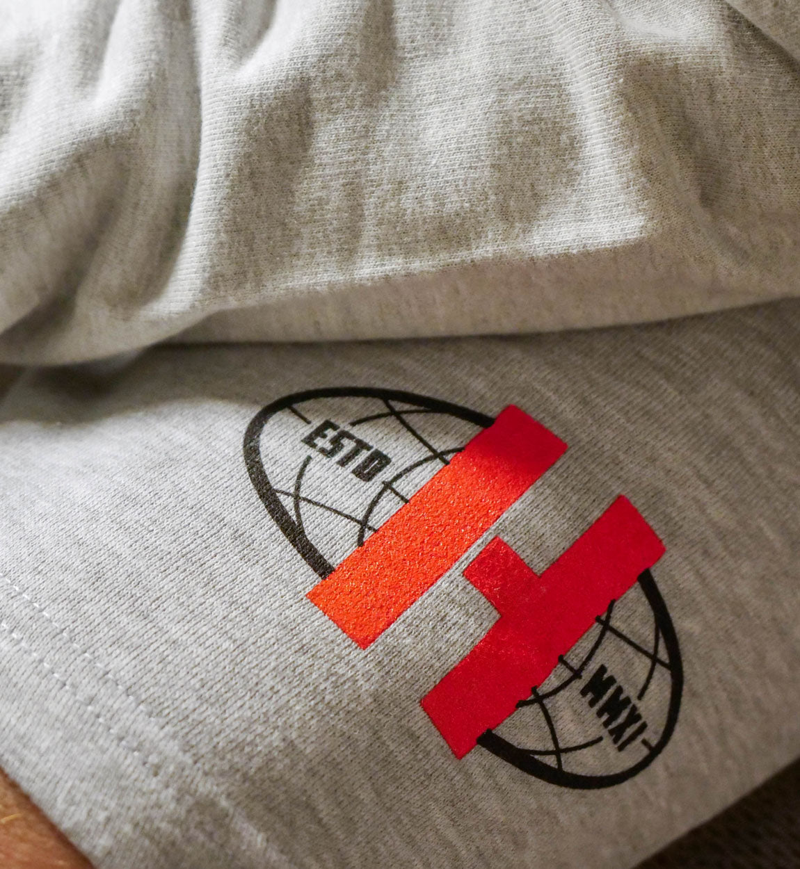 Hoonigan WORLDWIDE grey fleece shorts with logo on left leg, suitable for casual wear.