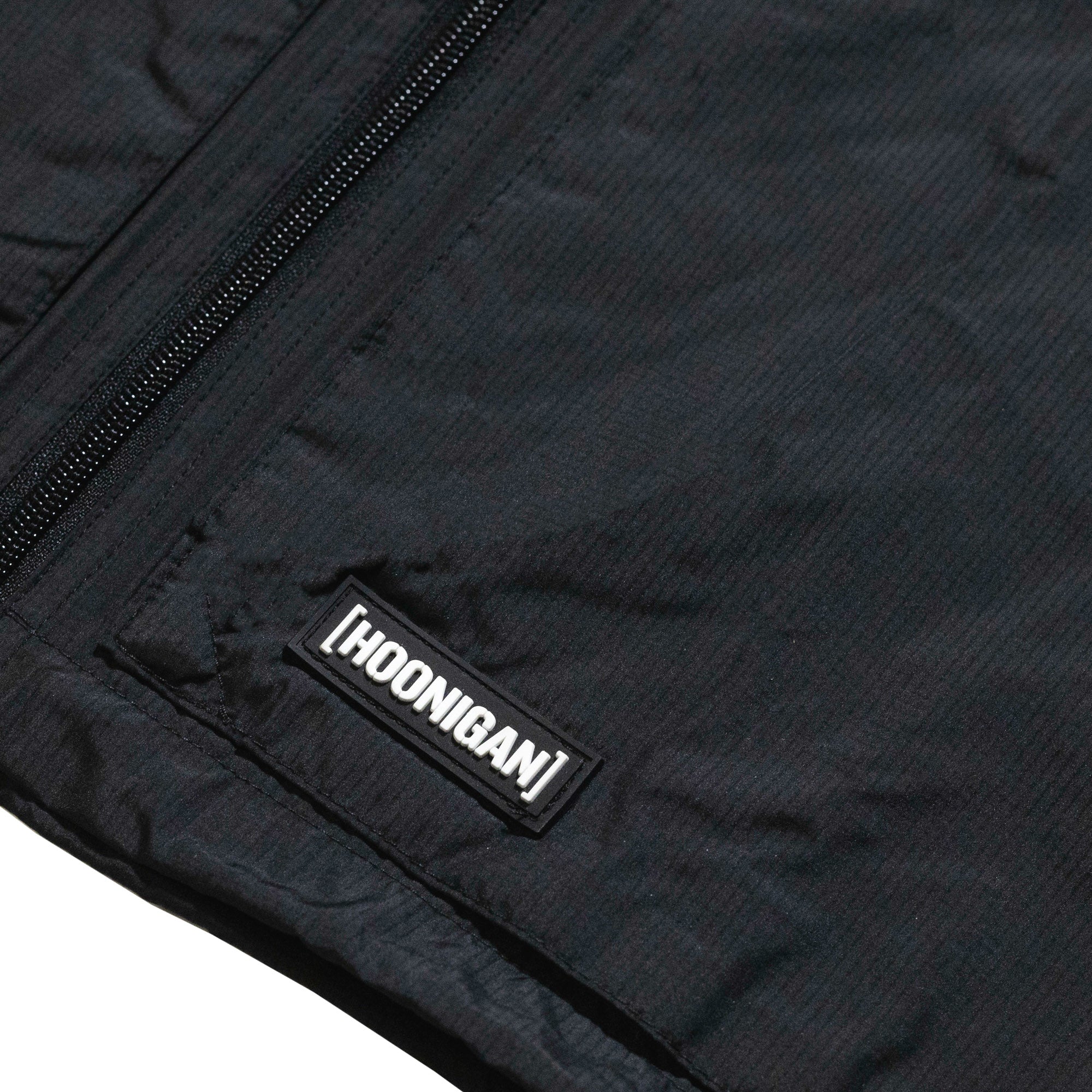 Hoonigan Motorsports windbreaker jacket featuring a bold logo design on the chest and vibrant colors.