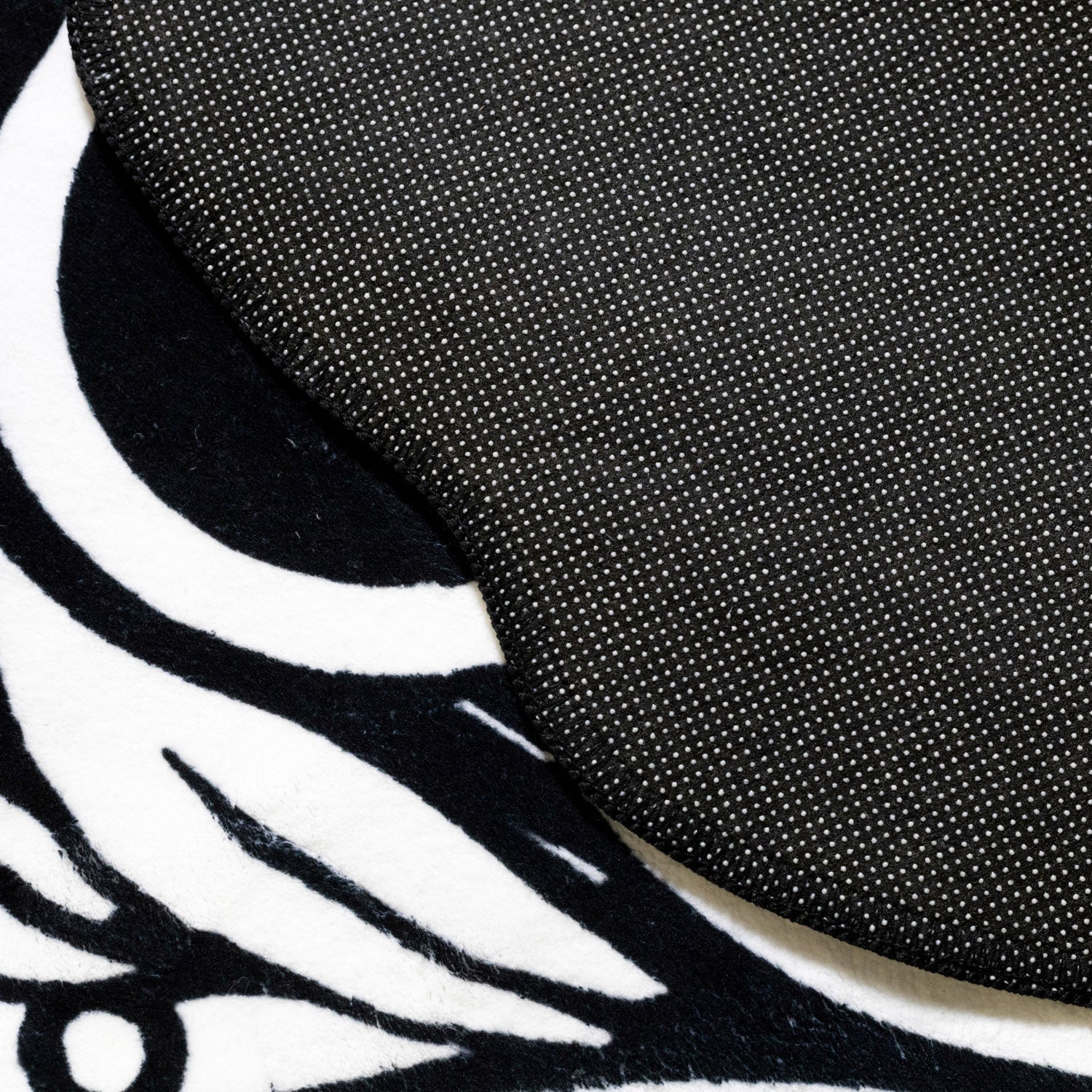 Hoonigan WORLDWIDE 3.75-foot rug featuring a bold graphic design in black and white.