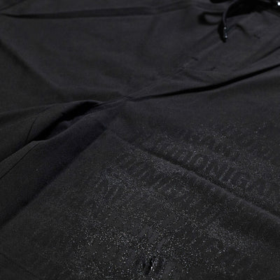 Hoonigan OIL SLICK Board Shorts featuring a sleek black design with a glossy logo print for a stylish look.