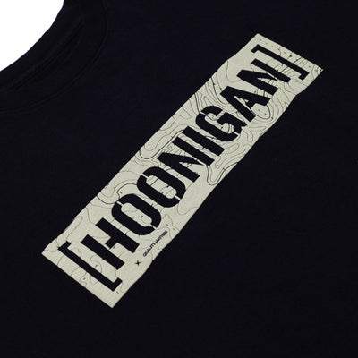 Black T-shirt with a beige rectangular graphic featuring "HOONIGAN" in bold black letters and a topographic map pattern.
