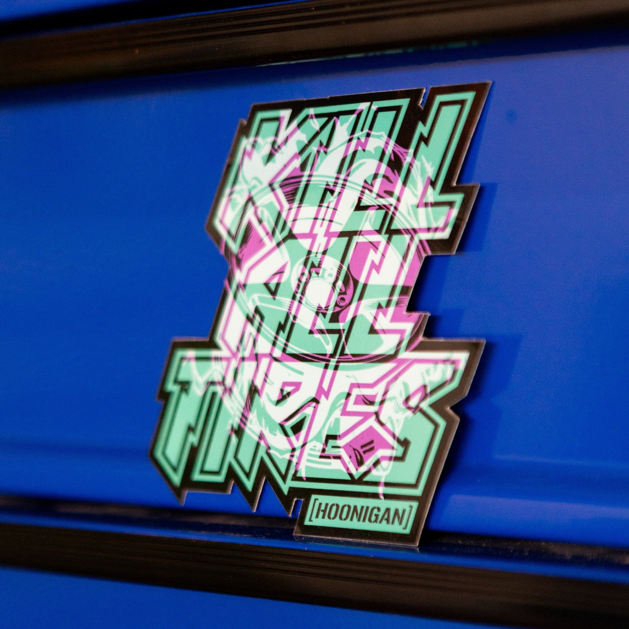 Hoonigan TREADWEAR KILL ALL TIRES sticker featuring bold, colorful lettering on a blue background.