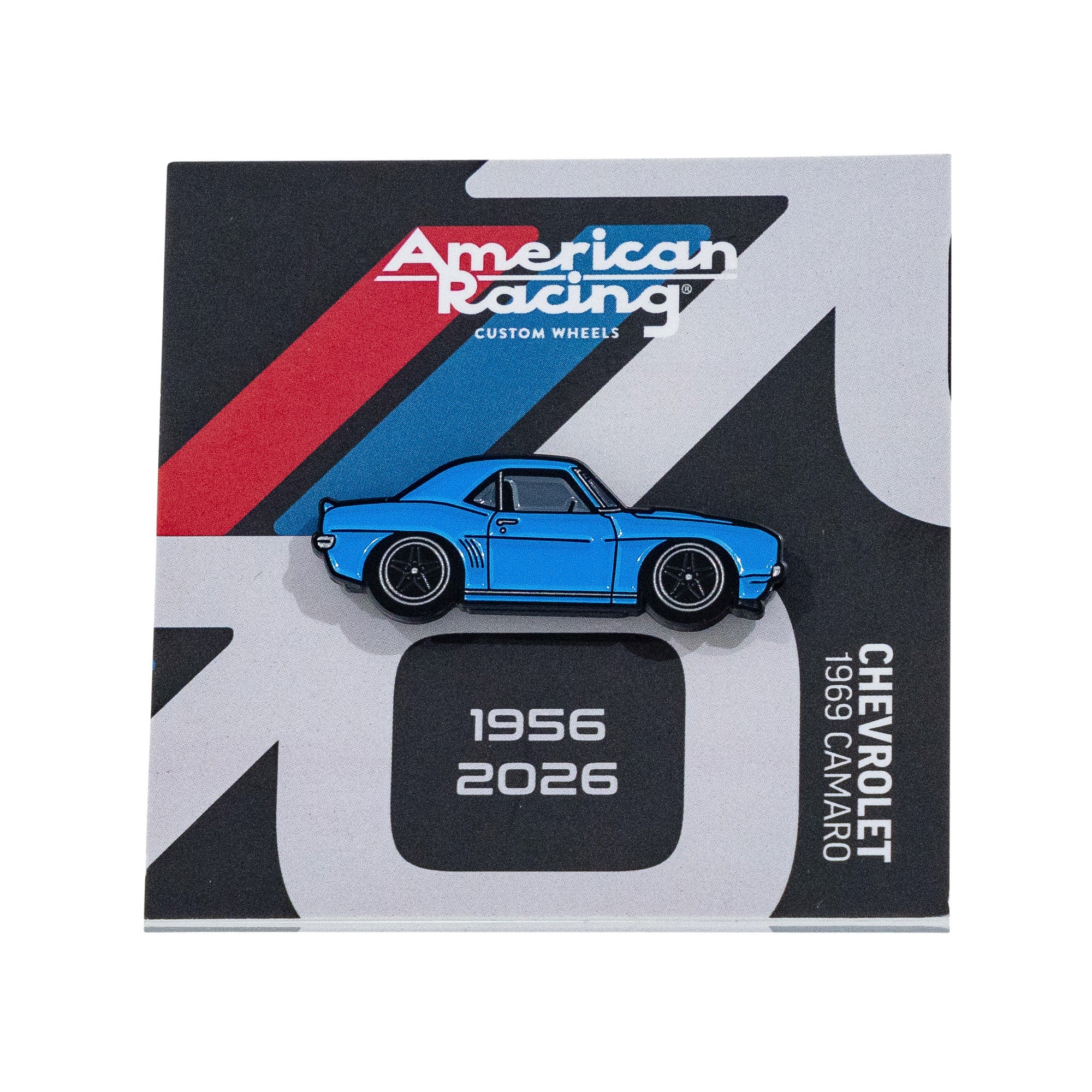 Blue collectible pin featuring a 1969 Chevrolet Camaro, displayed on an American Racing card with dates 1956-2026.