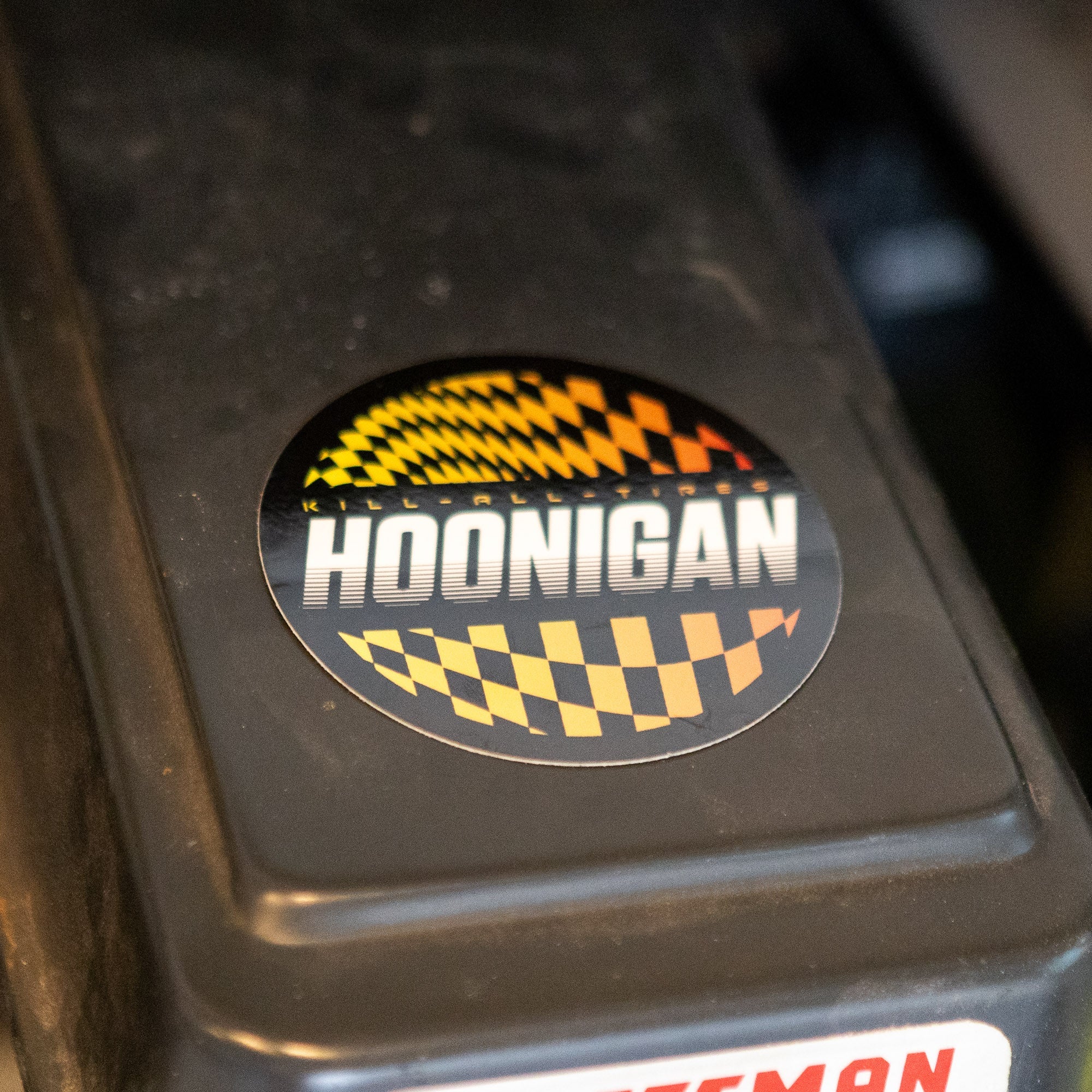 Hoonigan SLIDEWAYS sticker featuring a bold design with checkered patterns and vibrant colors, perfect for car enthusiasts.
