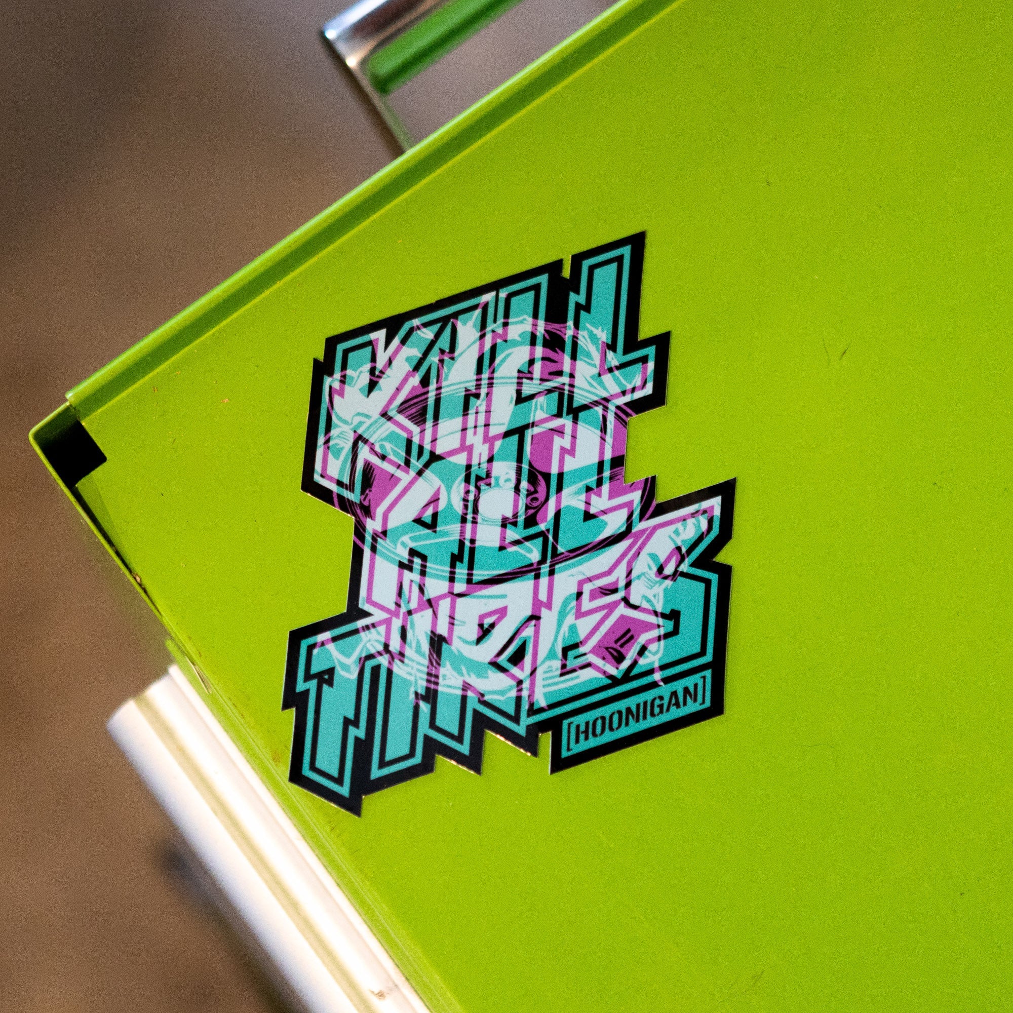 Hoonigan TREADWEAR KILL ALL TIRES sticker featuring bold, colorful text on a bright green background.