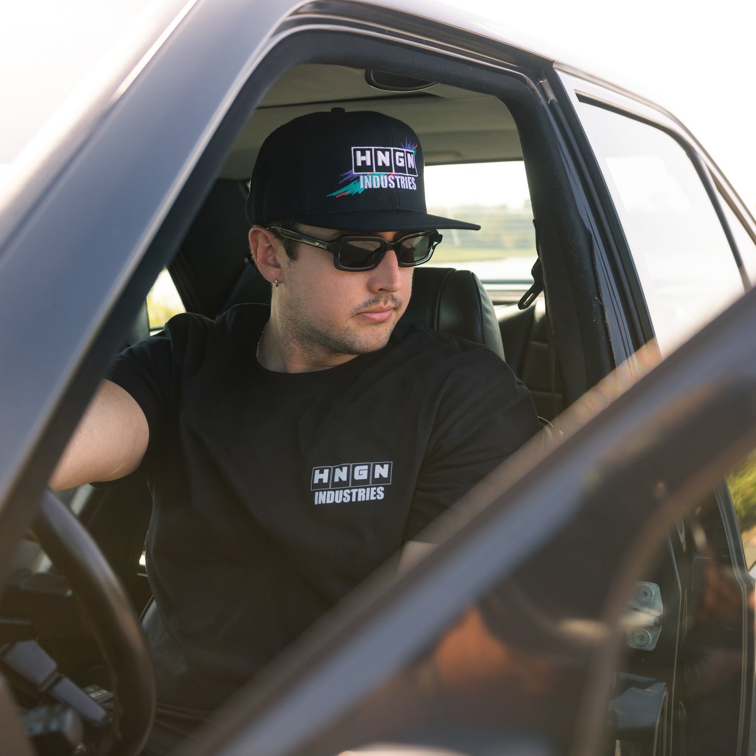 Hoonigan HNGN POWER Snapback Hat with black and white design, featuring a flat brim and adjustable back.