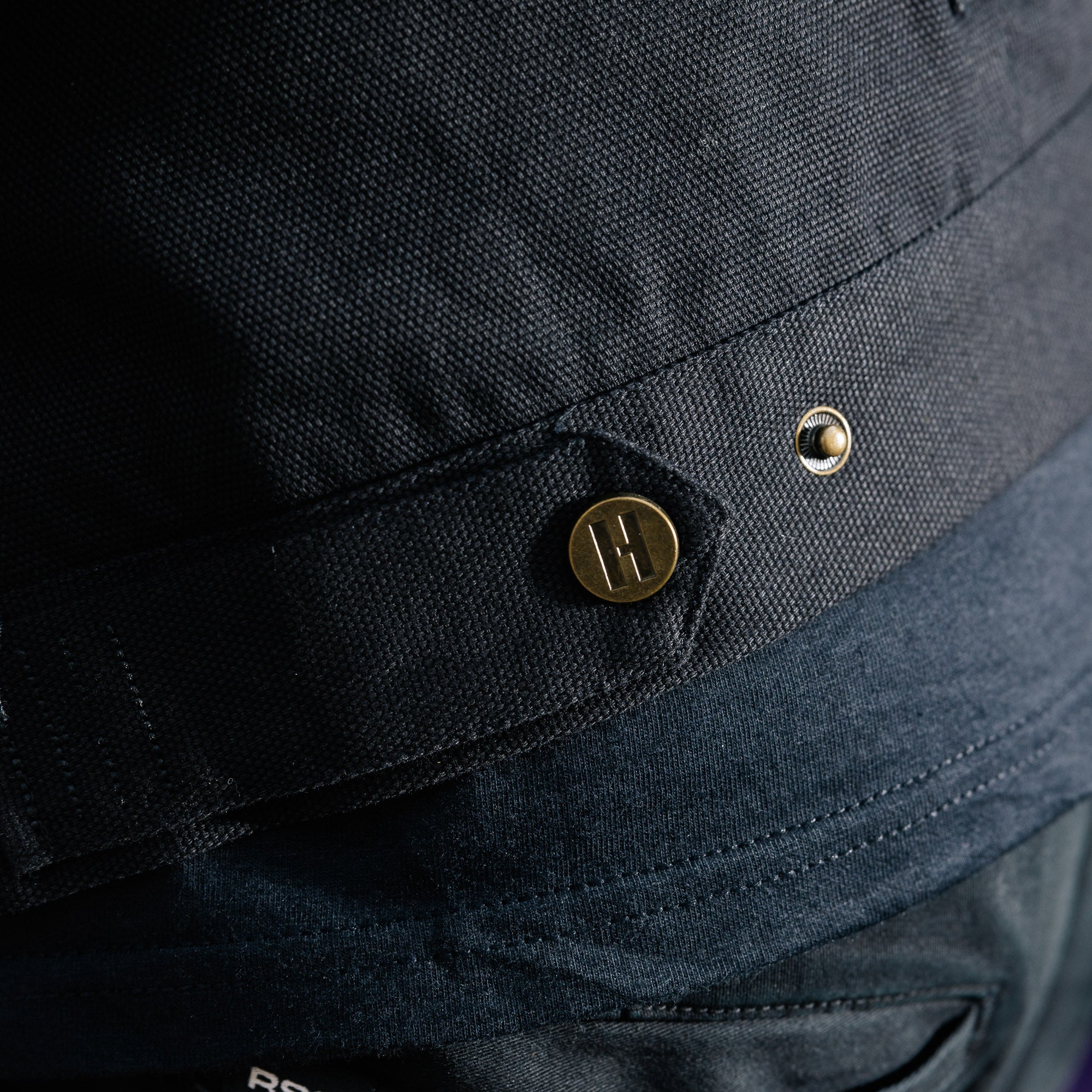 Hoonigan KNUCKLEBUSTERS Jacket in black with white logo and graphic designs, featuring a front zipper and pockets.