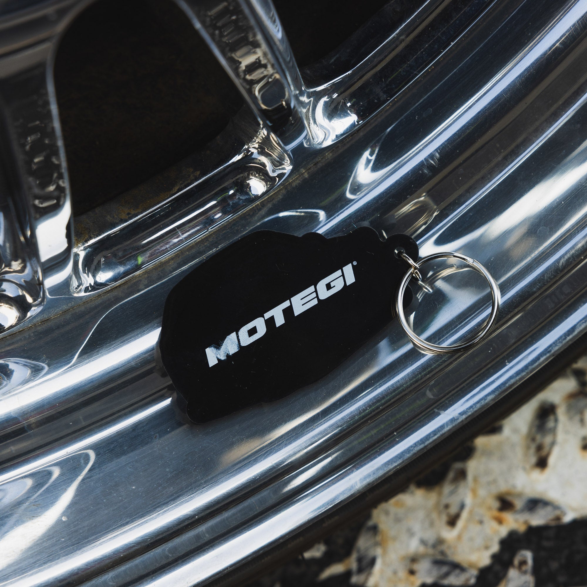 Motegi SD Series keychain featuring a sleek design with a metal finish, logo engraving, and a durable keyring attachment.