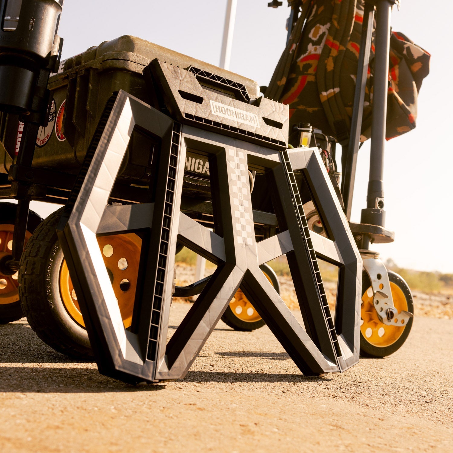 Hoonigan TRACK DAY collapsible stool with black and white branding, featuring a sturdy aluminum frame and comfortable seating.