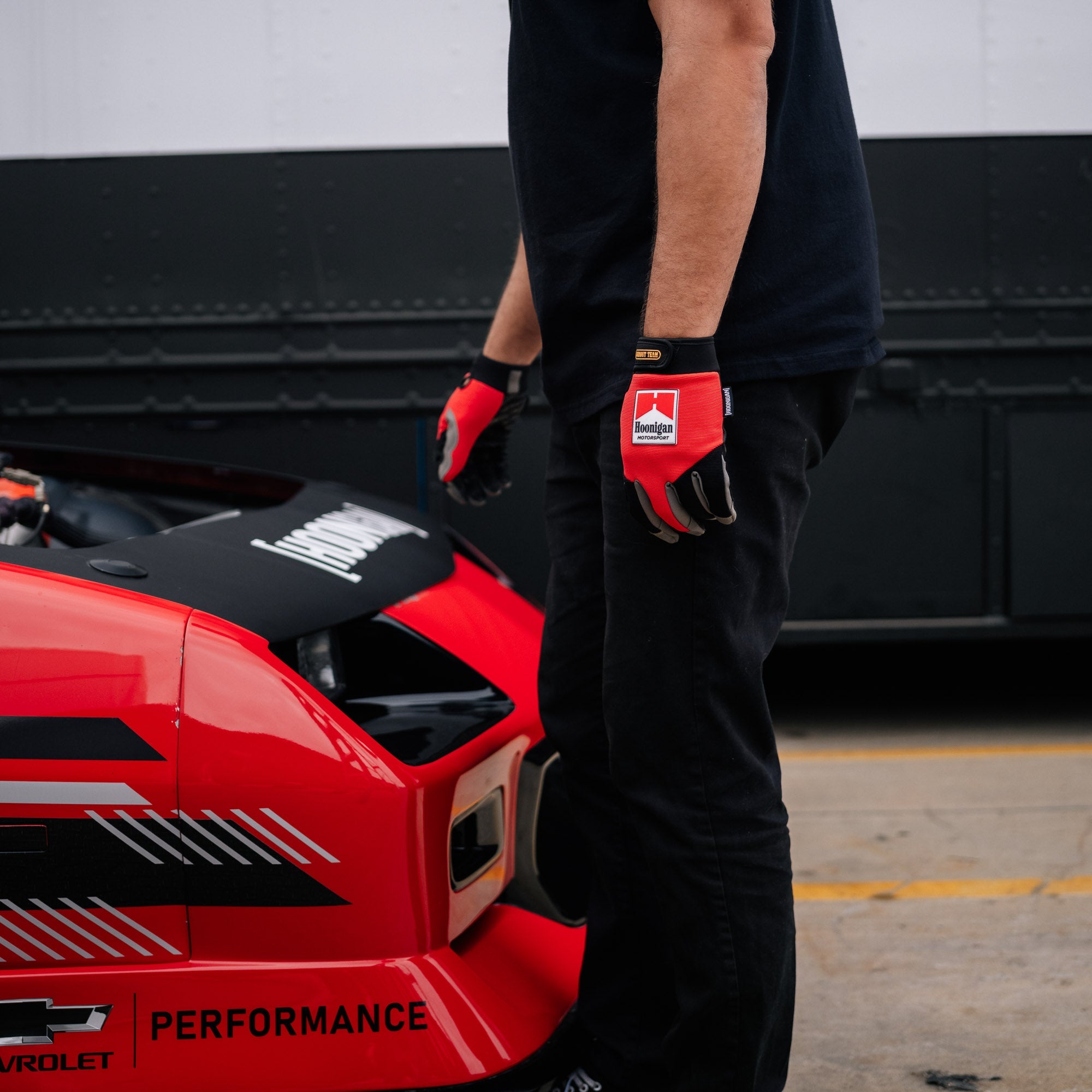 Hoonigan SURGEON GENERAL gloves featuring a black design with white accents and the Hoonigan logo.