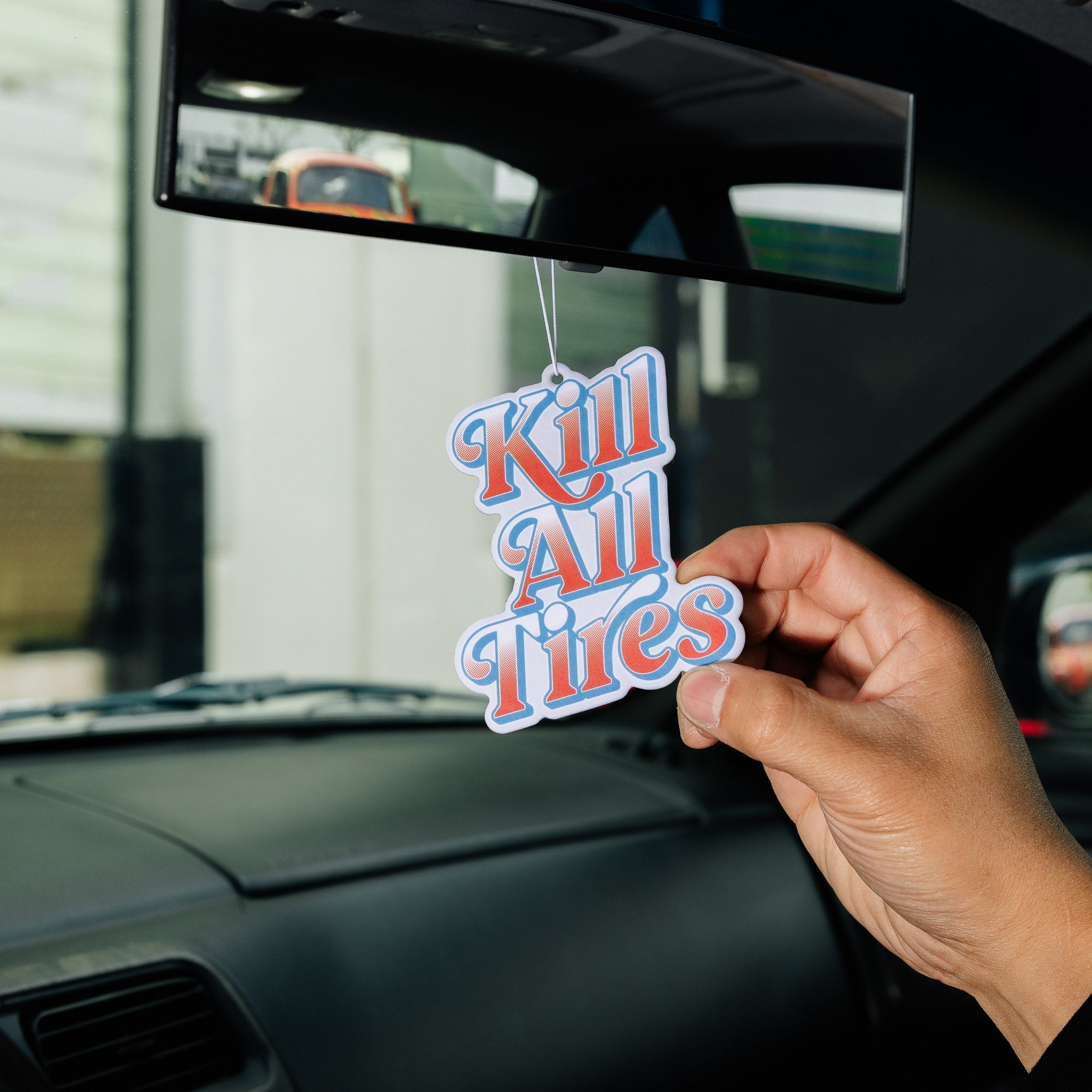 Hoonigan KILL ALL TIRES V2 Air Freshener featuring a vibrant design with bold text and graphic elements, perfect for automotive enthusiasts.