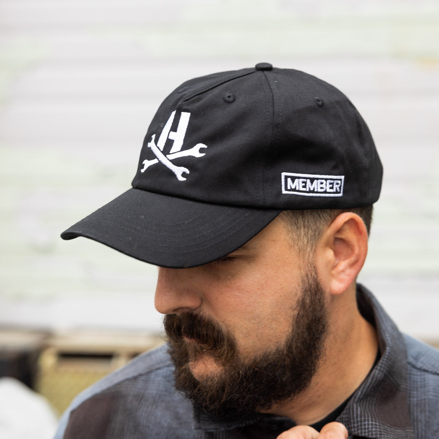 Hoonigan MAYHEM unstructured strapback hat featuring a black fabric, embroidered logo, and adjustable back strap.