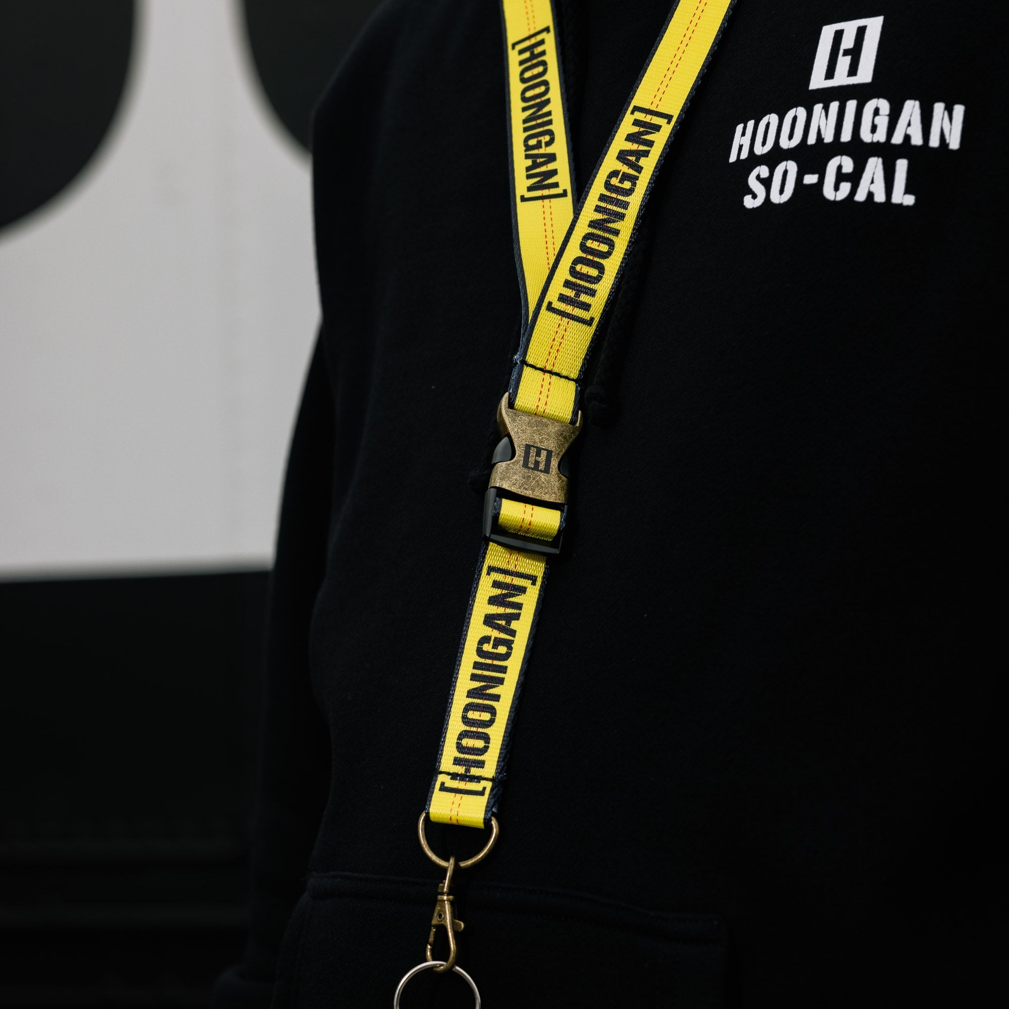 Hoonigan RATCHET STRAP lanyard with bold branding and vibrant colors.