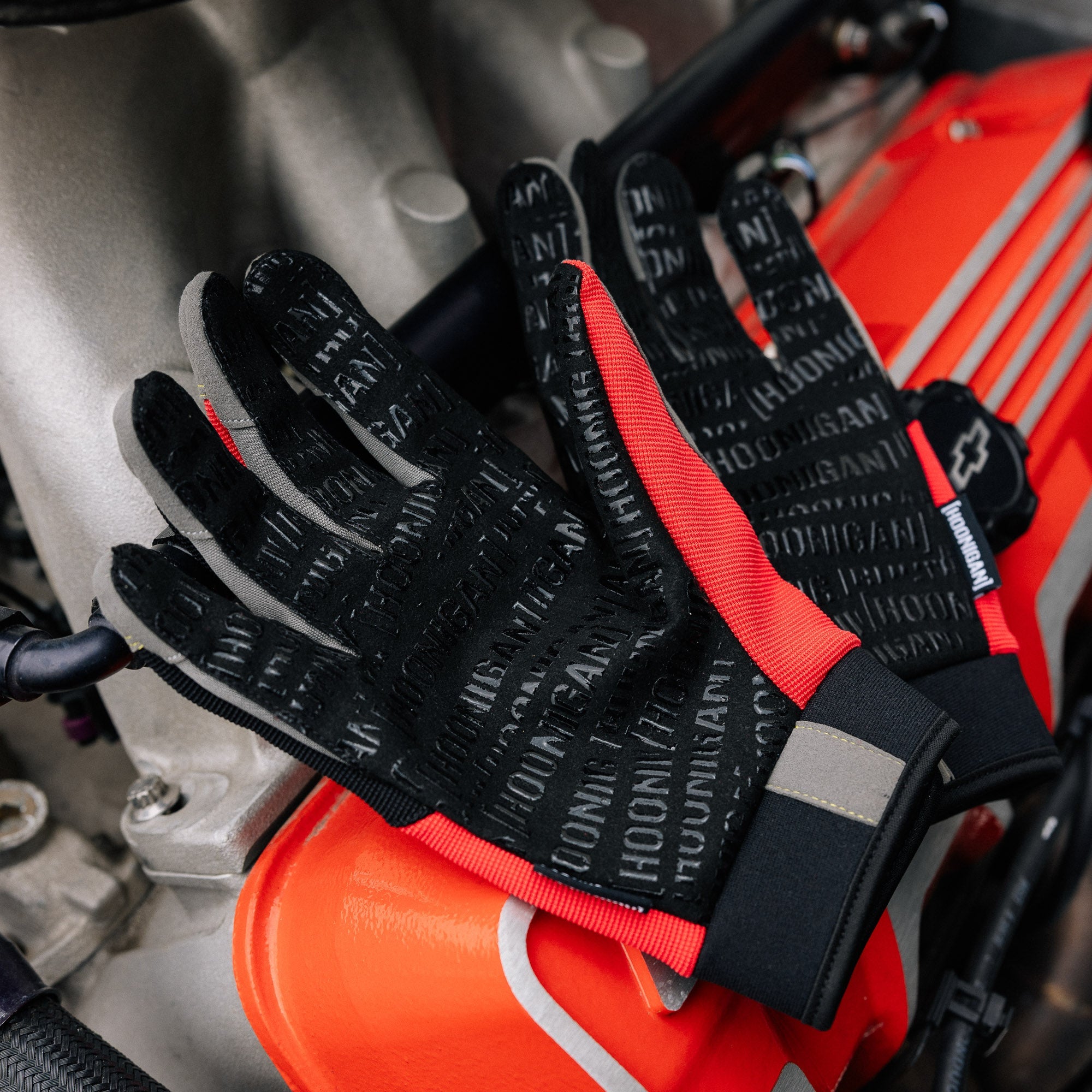 Hoonigan SURGEON GENERAL gloves featuring a bold design with white and black colors, designed for motorsport enthusiasts.