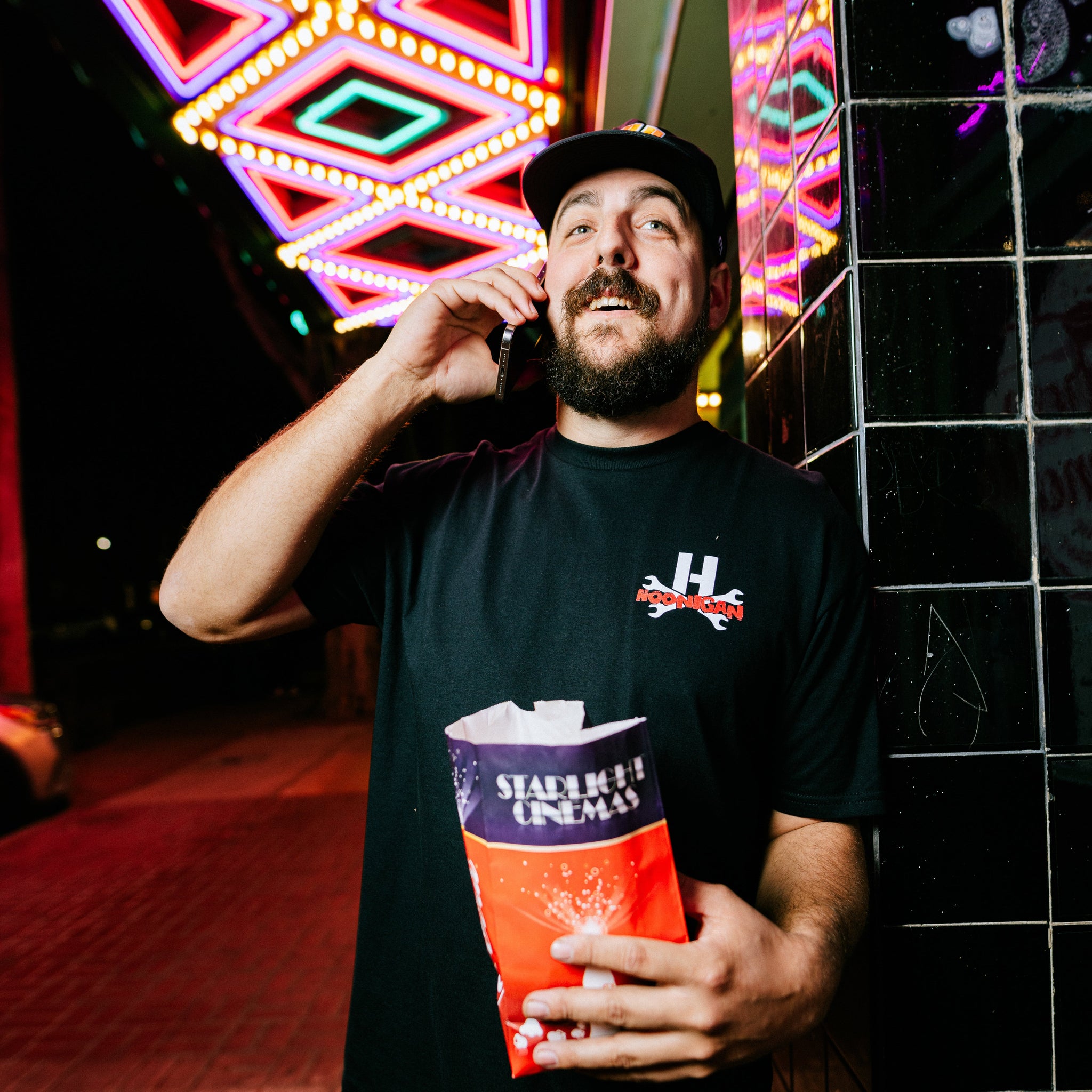 Hoonigan DOUBLE FEATURE Short Sleeve Tee in black with vibrant graphic print on the front.