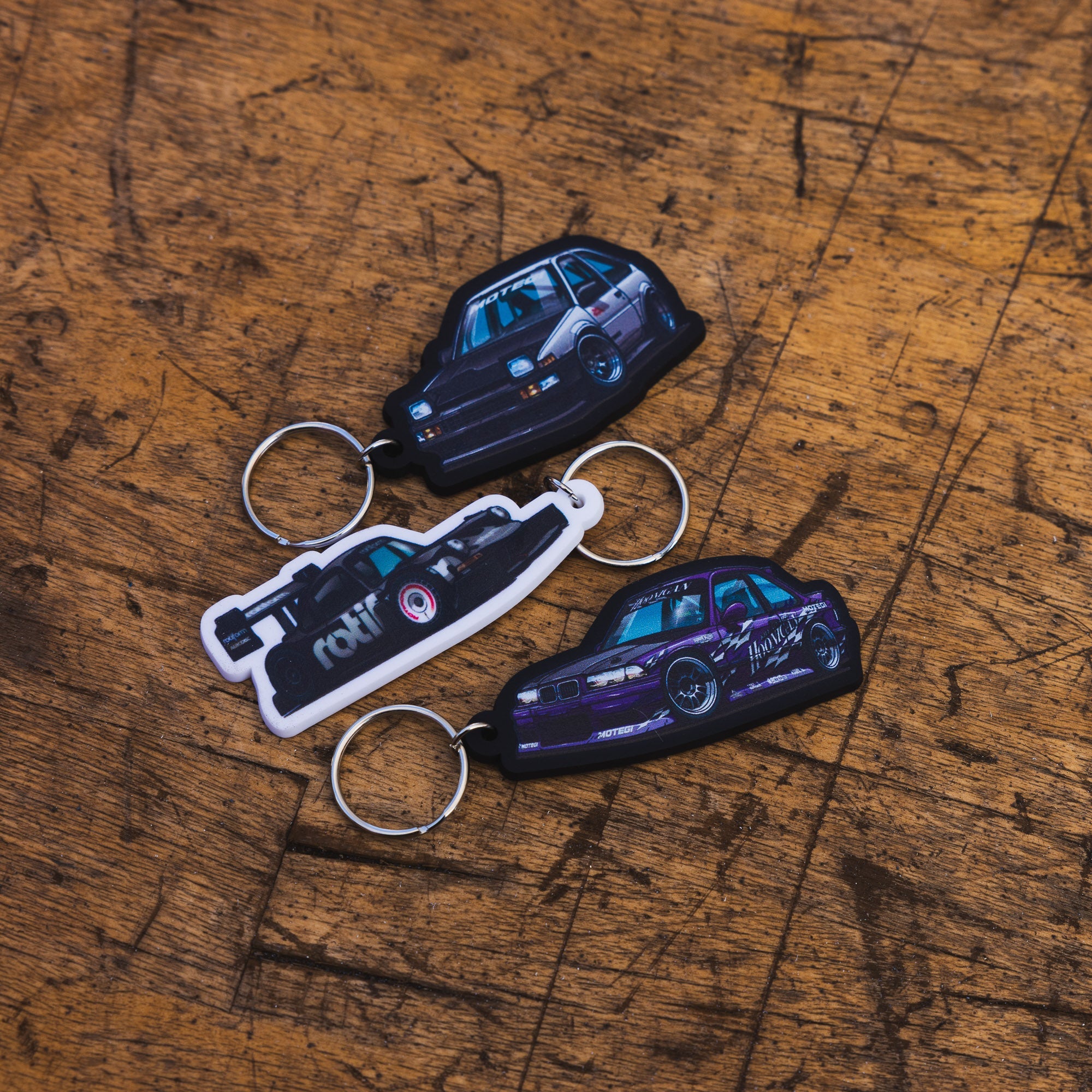 Hoonigan SD Series keychain featuring a black and white design with the Hoonigan logo and tire tread pattern.