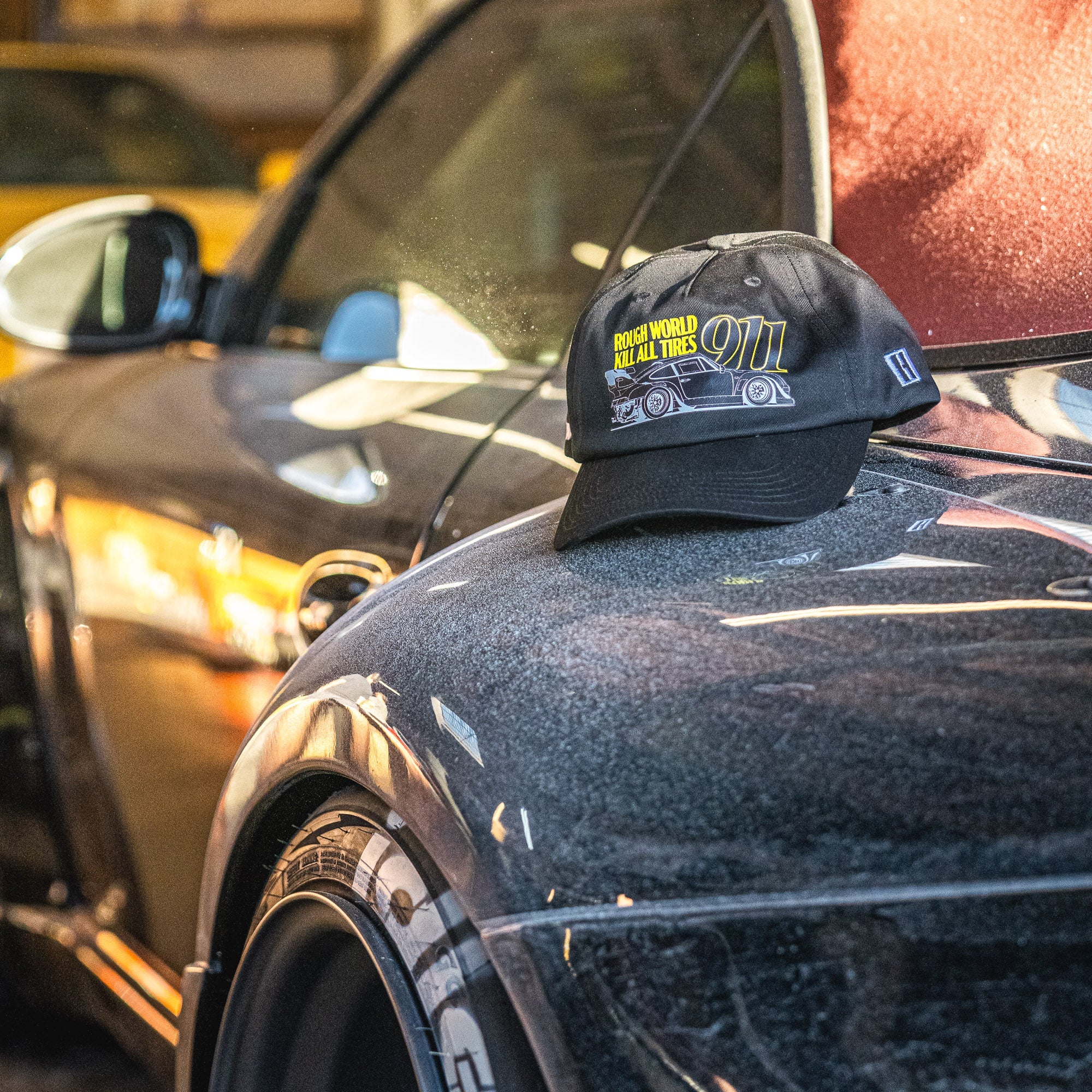 Hoonigan x RWB ROUGH WORLD KILL ALL TIRES unstructured strapback hat in black with white text and logo.