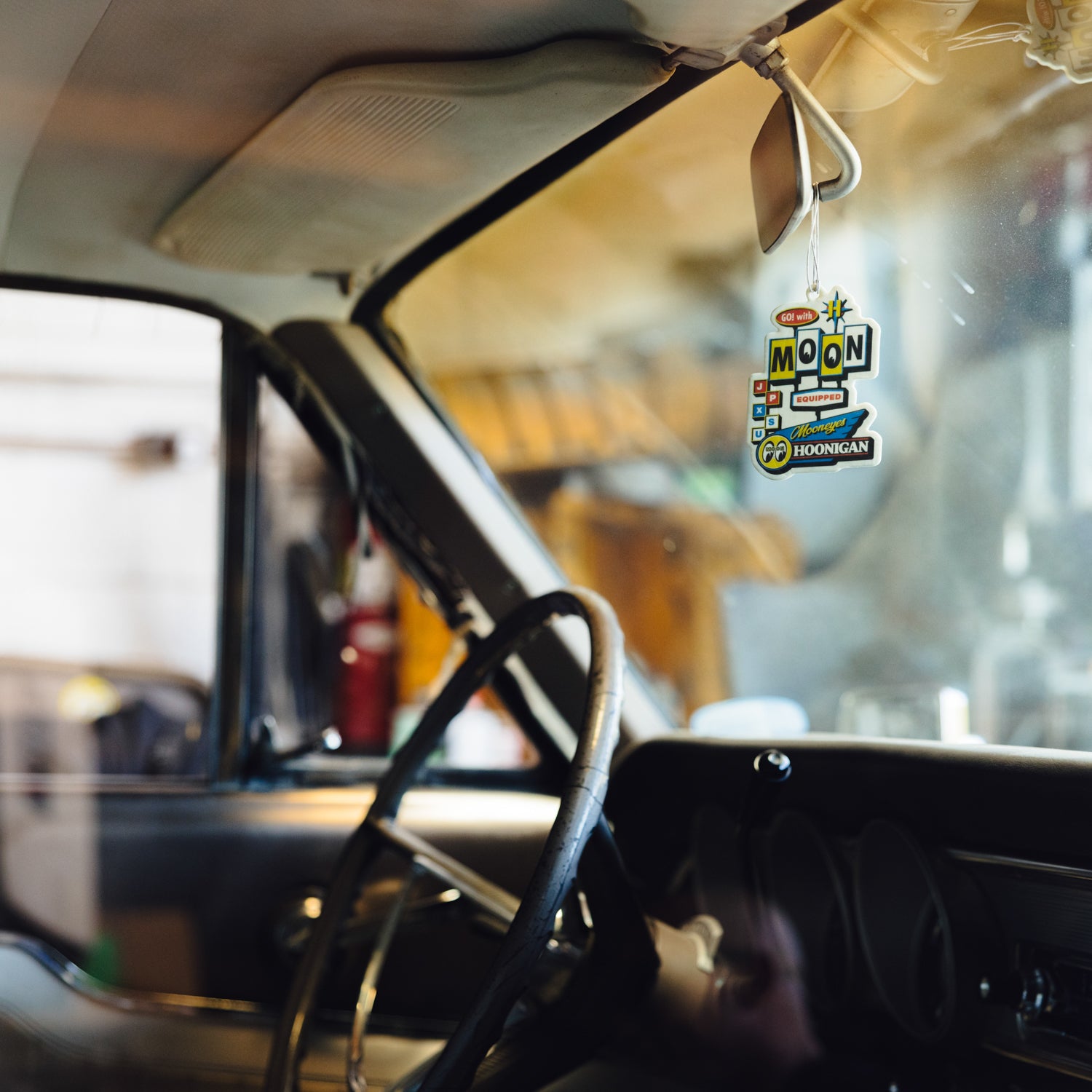 Hoonigan x Mooneyes MOON MOTEL air freshener featuring a retro motel design with vibrant colors and iconic logos.