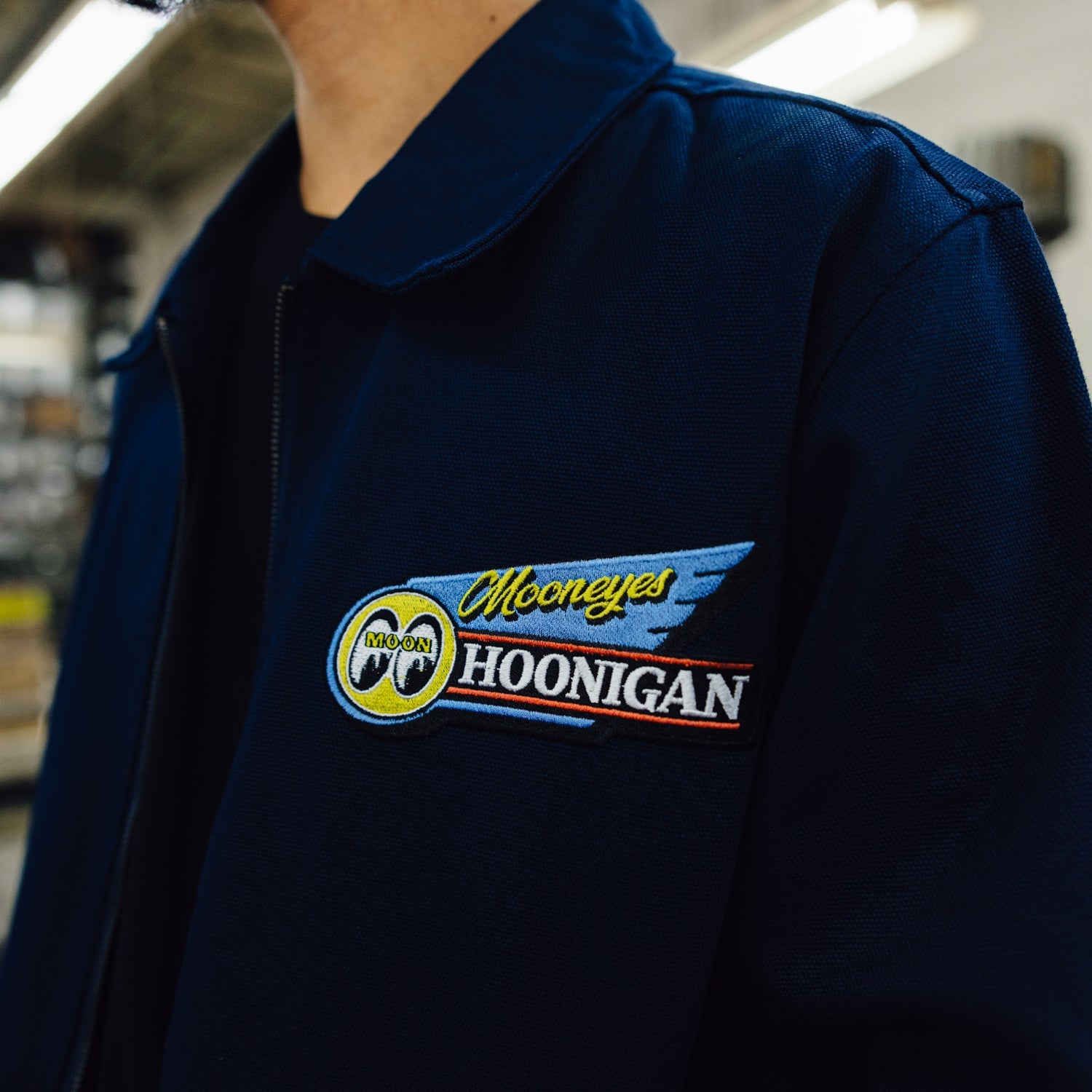Hoonigan x Mooneyes MOON MOTEL Jacket featuring a vintage-inspired design with bold graphics and a relaxed fit, displayed against a neutral background.