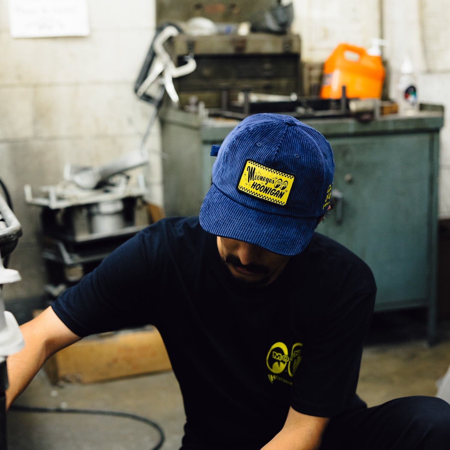 Black unstructured strapback hat featuring Hoonigan and Mooneyes logos, with a classic adjustable back strap.