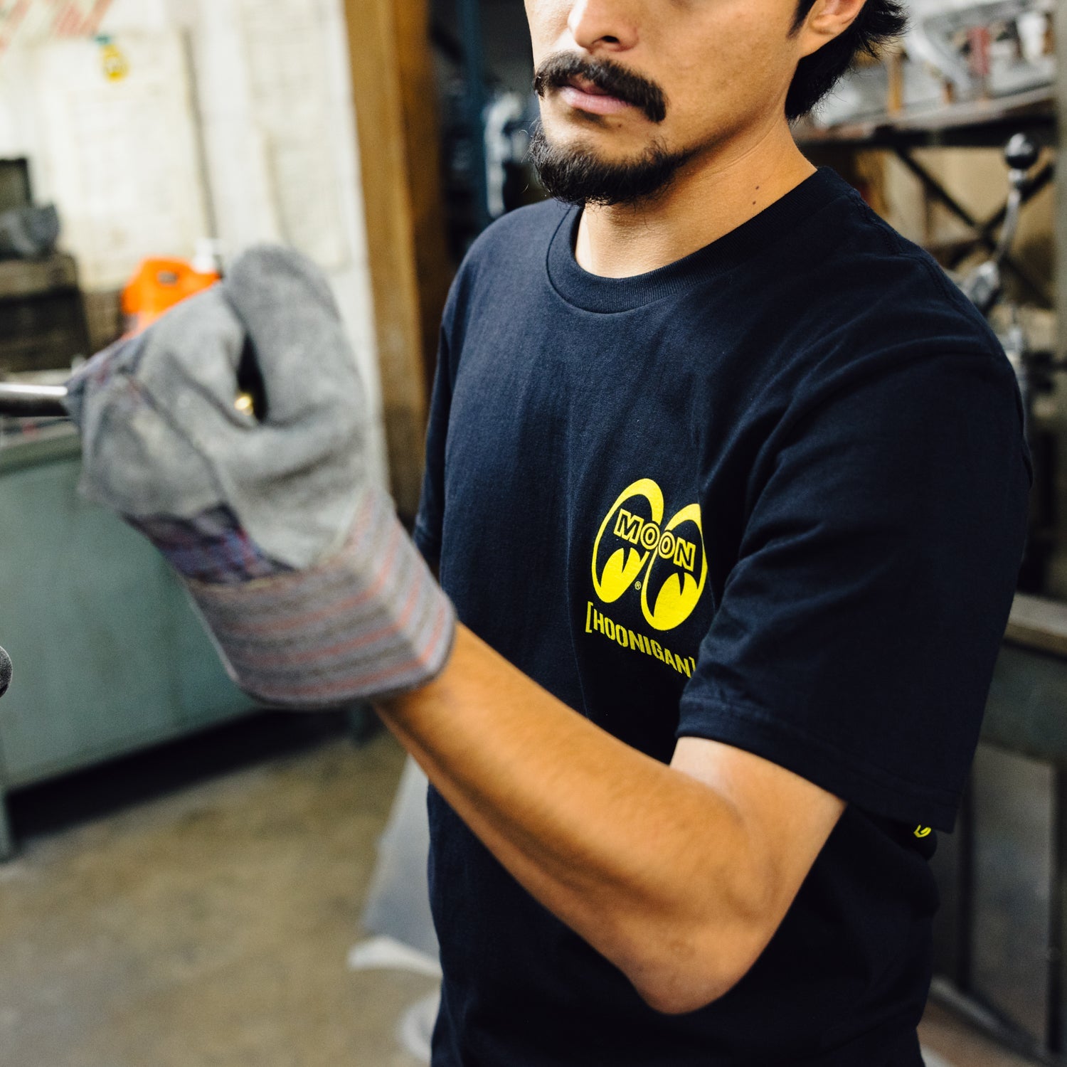 Hoonigan x Mooneyes SO CAL Short Sleeve Tee featuring a black and yellow graphic design with logo print on the front.