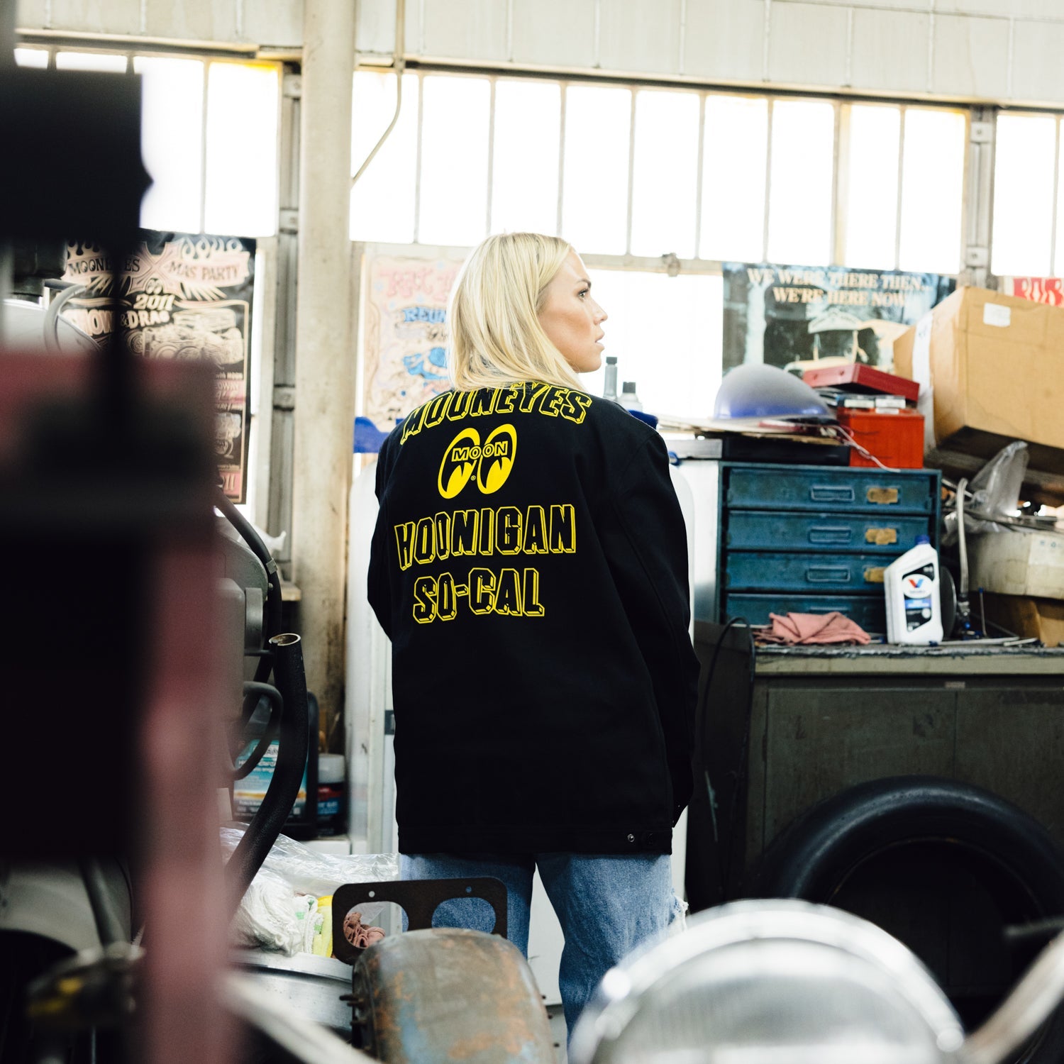 Hoonigan x Mooneyes SO CAL Jacket featuring a black design with vibrant yellow accents and logos on the front and back.