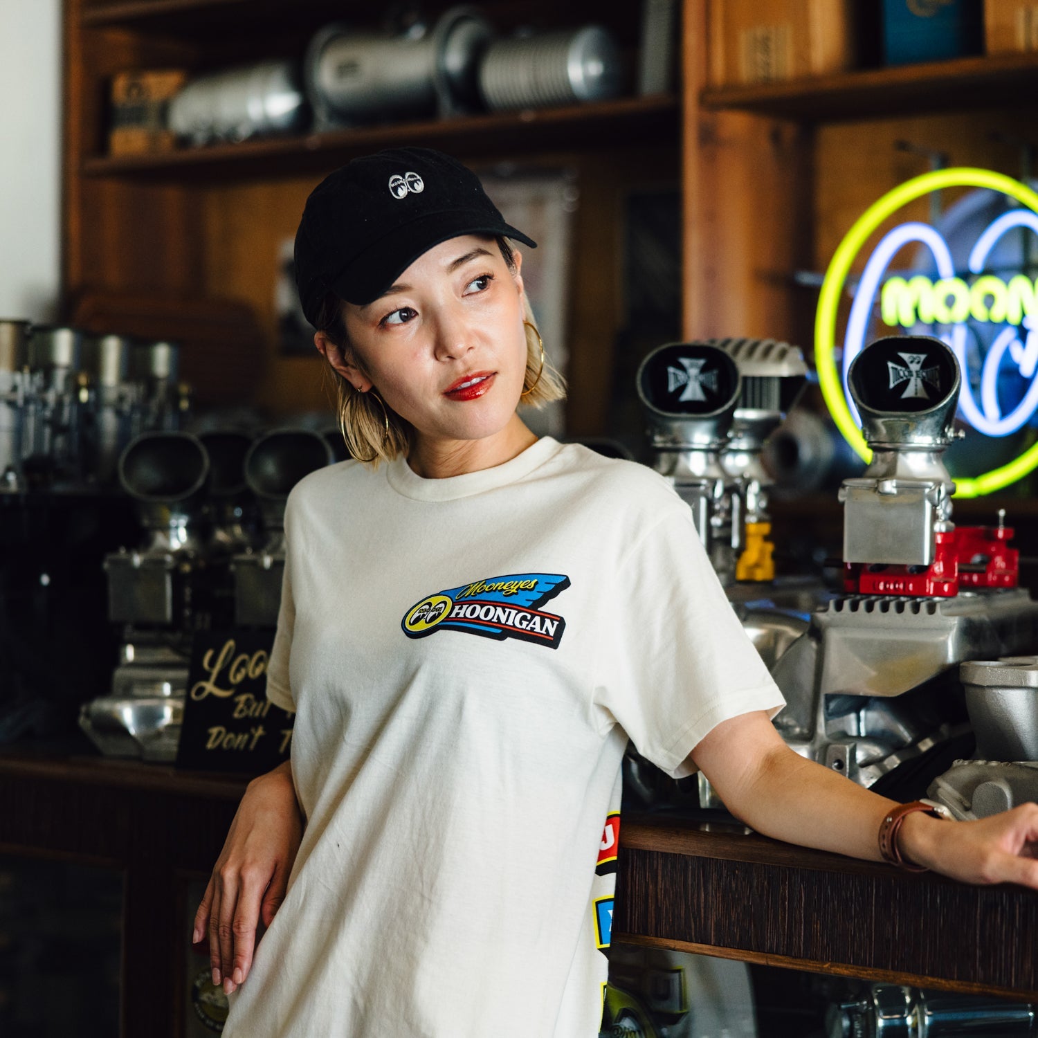 Hoonigan x Mooneyes MOONMOTEL Short Sleeve Tee featuring a graphic print on a black fabric.
