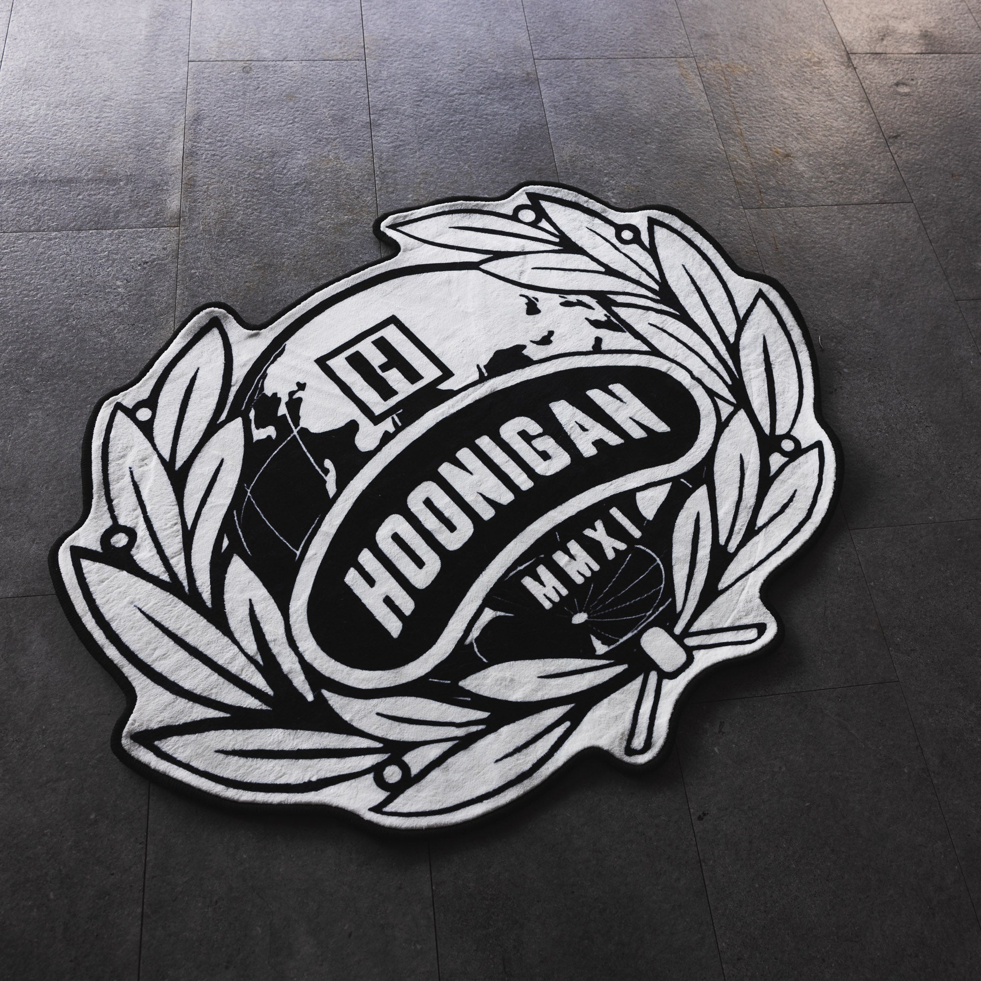 Hoonigan WORLDWIDE 3.75' rug featuring a bold black and white design with the Hoonigan logo.