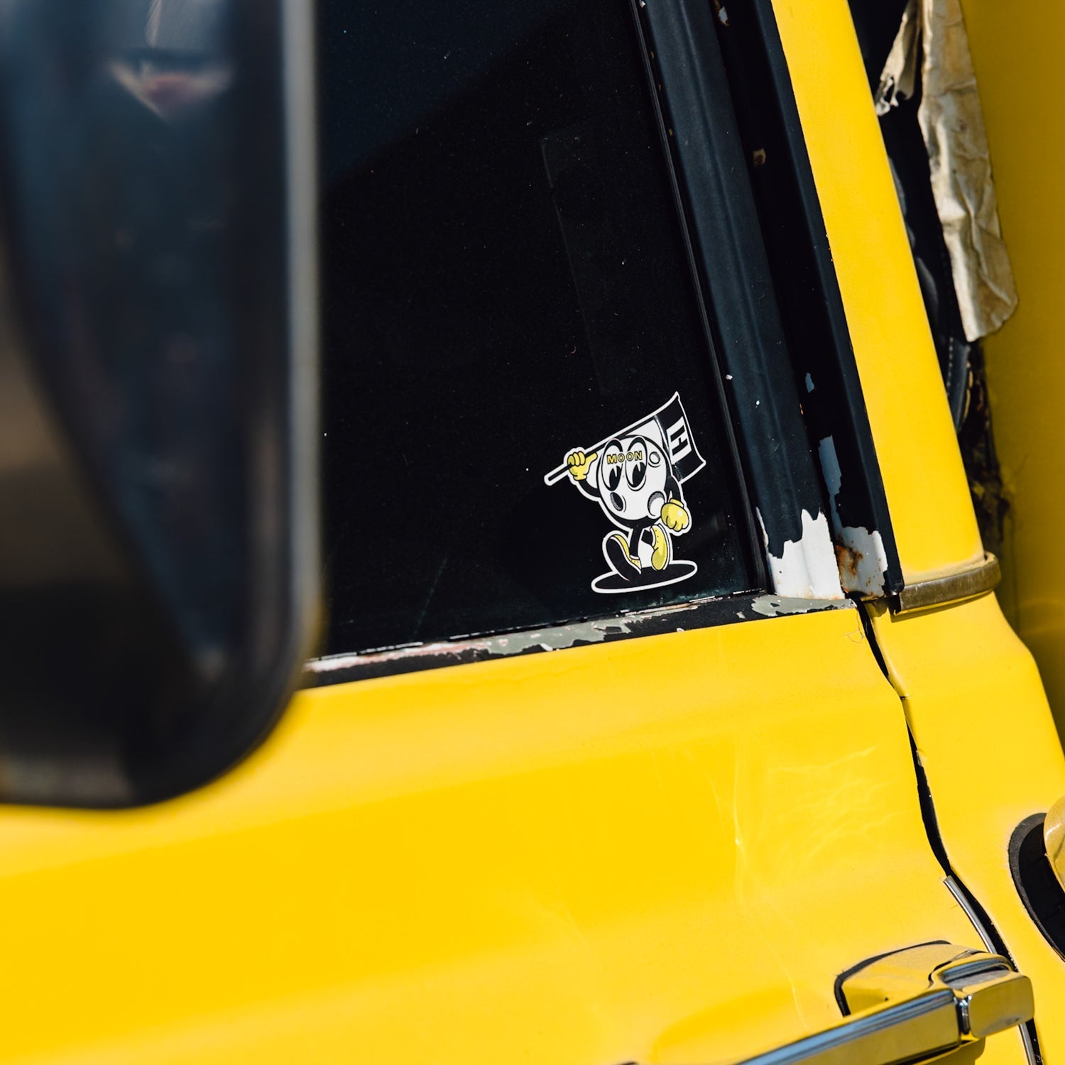 Hoonigan x Mooneyes MOON MAN sticker measuring 3.5 inches, featuring a vibrant design of a cartoon character with a playful expression and a starry background.