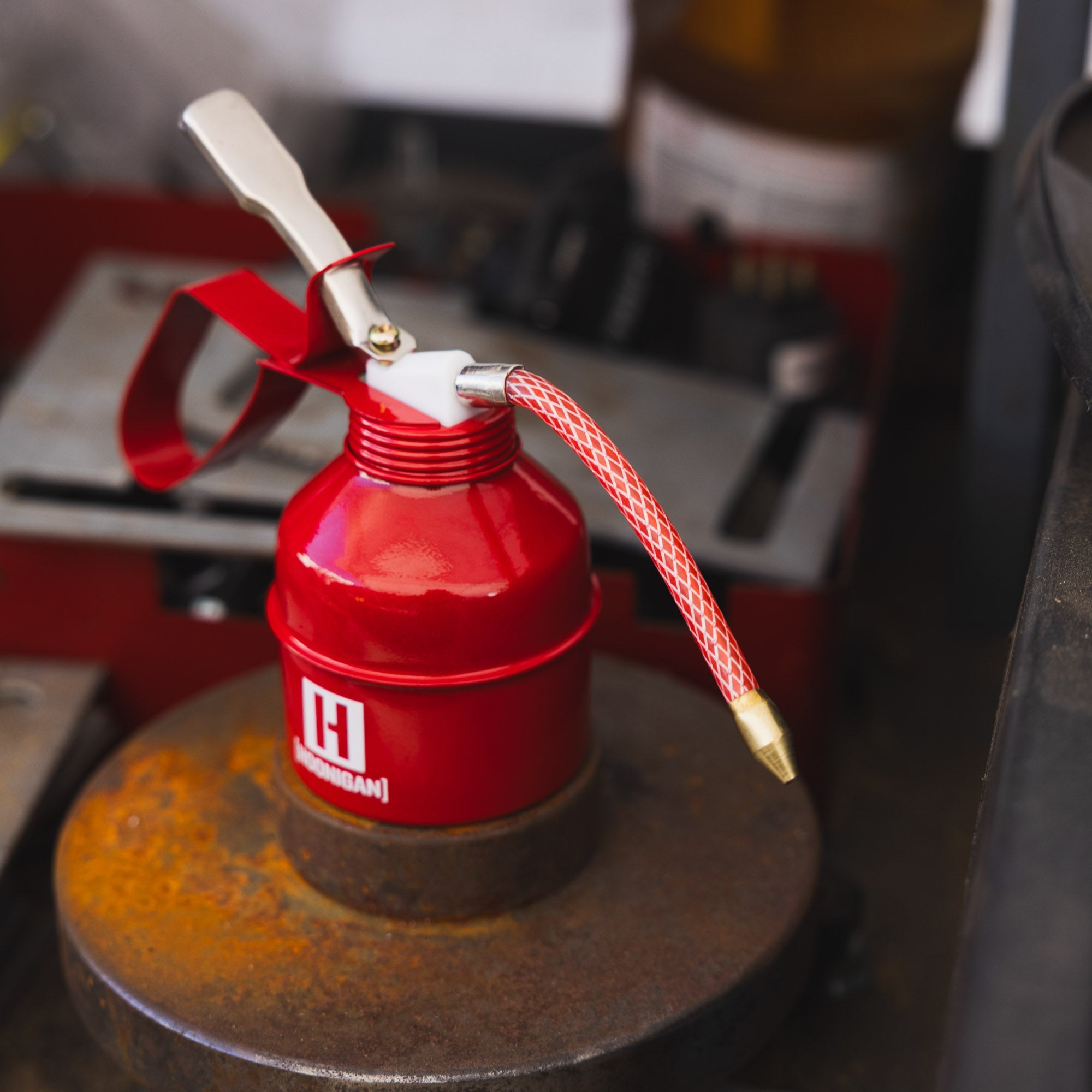 Hoonigan oil can featuring a bold black and white design with a vintage racing aesthetic.
