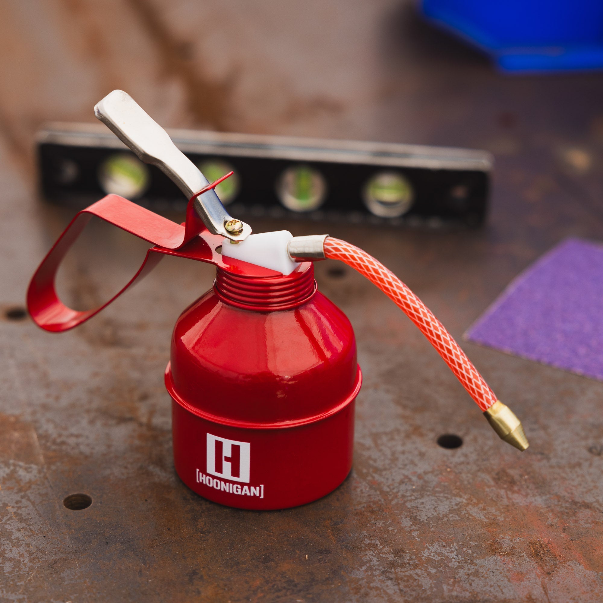 Hoonigan branded oil can in black with white logo, featuring a vintage design and sturdy handle.