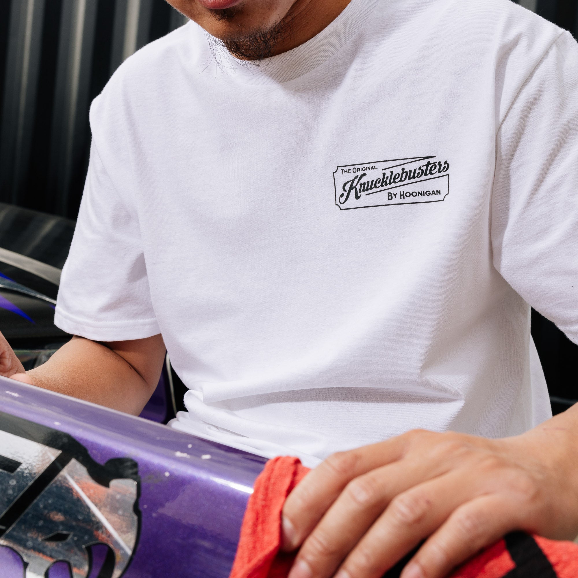 Hoonigan KNUCKLEBUSTERS AUTO REPAIR Short Sleeve Tee featuring a vintage style graphic and a relaxed fit in black.