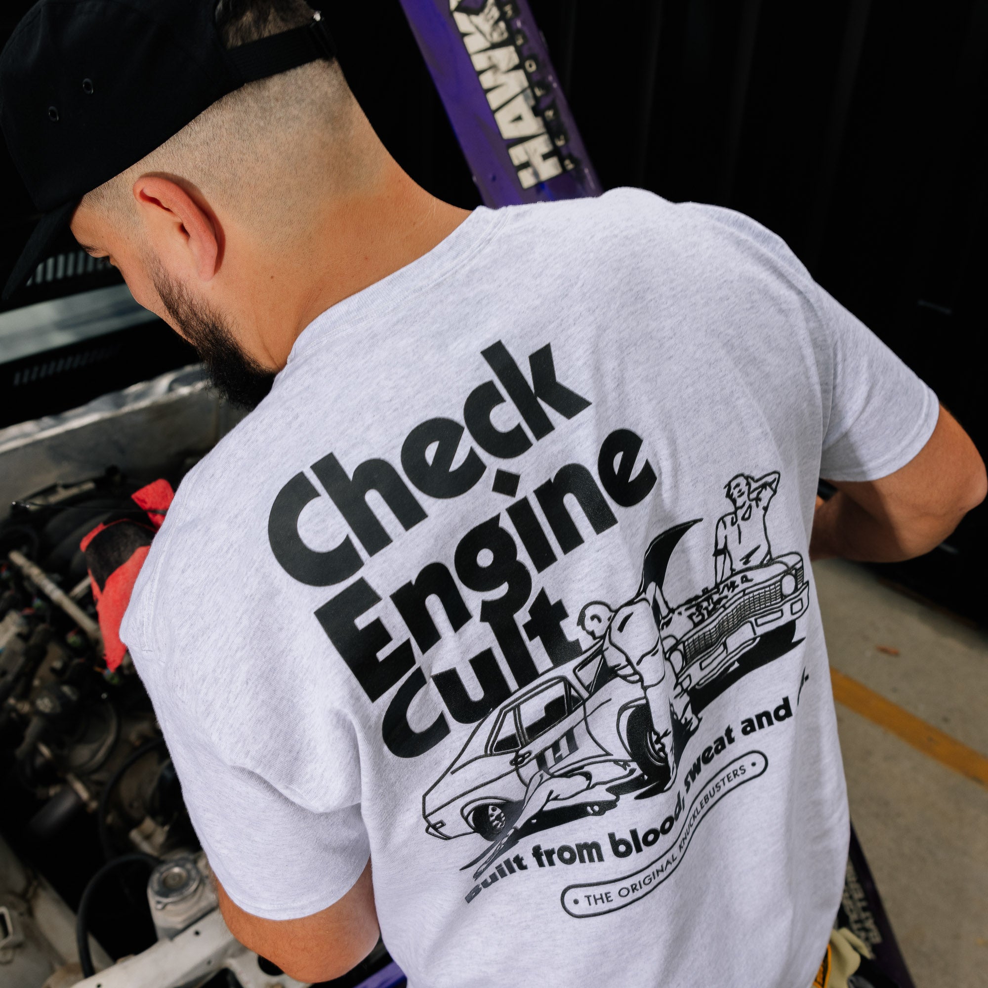 Hoonigan CHECK ENGINE CULT Short Sleeve Tee featuring a bold graphic design on a black cotton fabric.