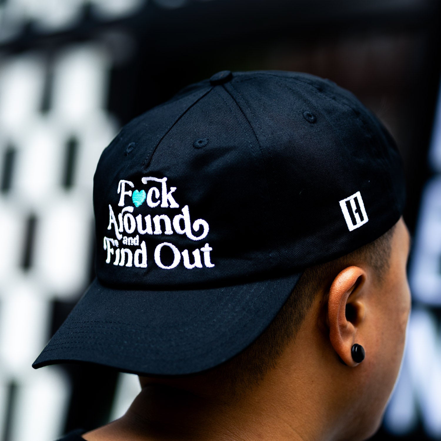 Hoonigan FIND OUT Unstructured Strapback Hat in black with a white logo patch.